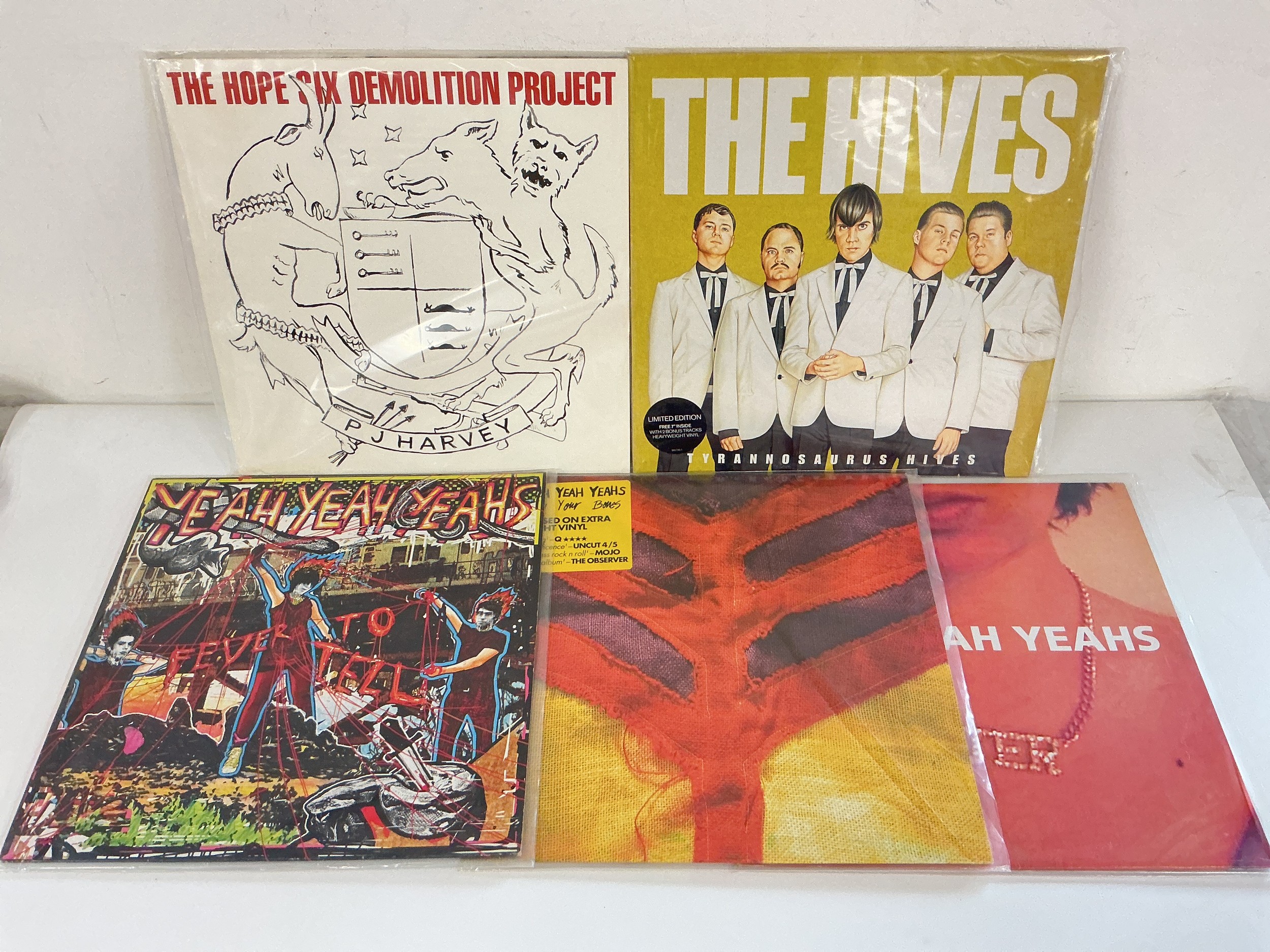Four alt rock LPs and a 12" single by Yeah Yeah Yeahs, The Hives and PJ Harvey.