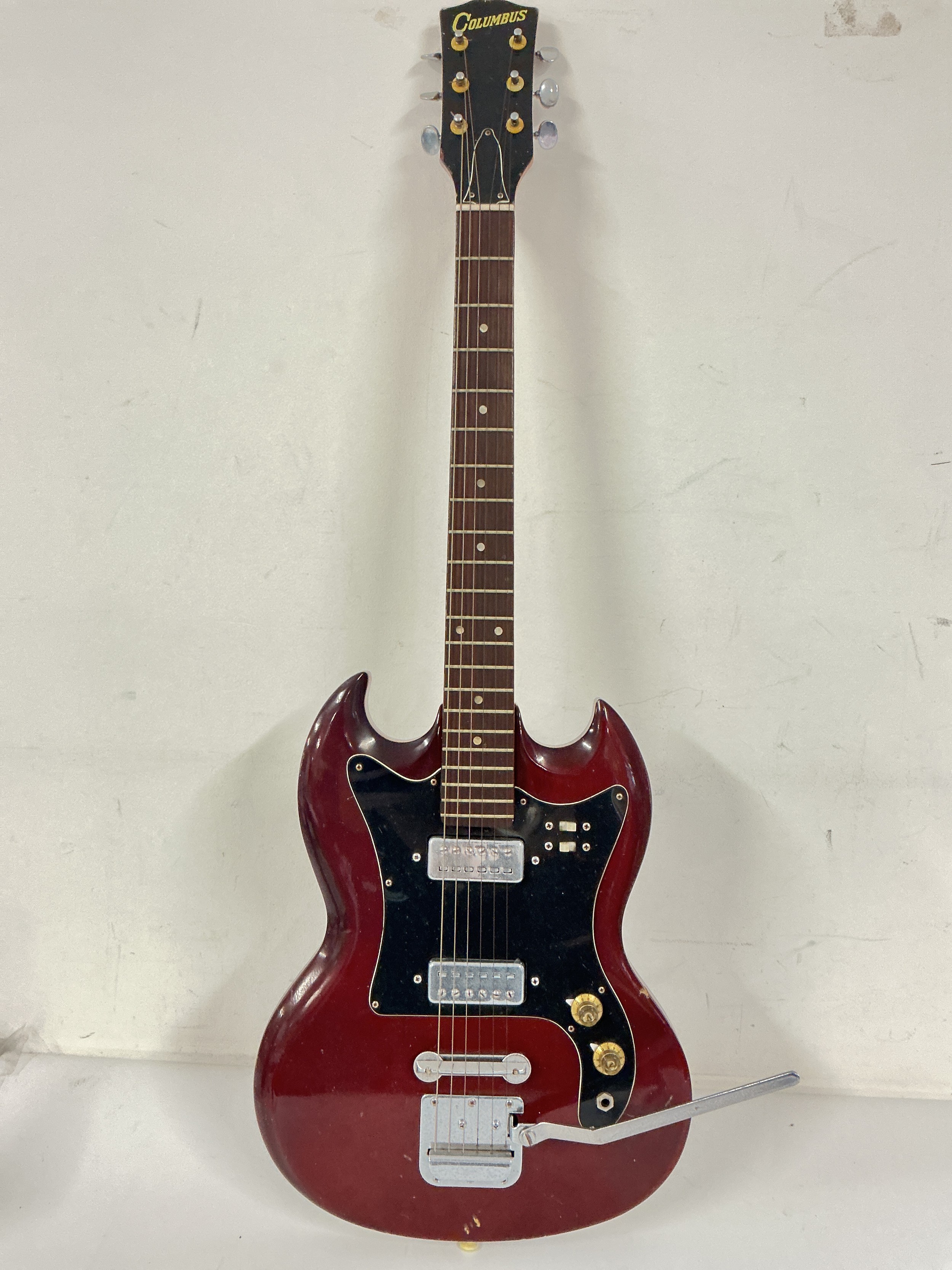 A Columbus SG style electric guitar, no case.