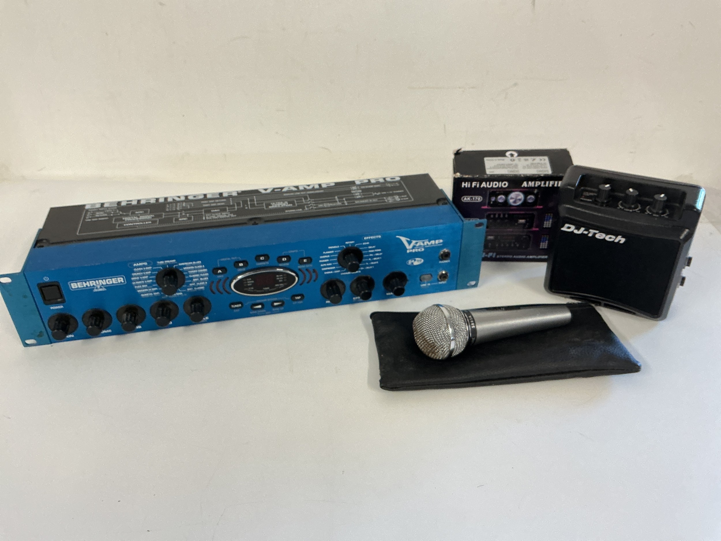 A Behringer V-Amp Pro, a Shure 588SA microphone (a/f) and two mini amps (4).