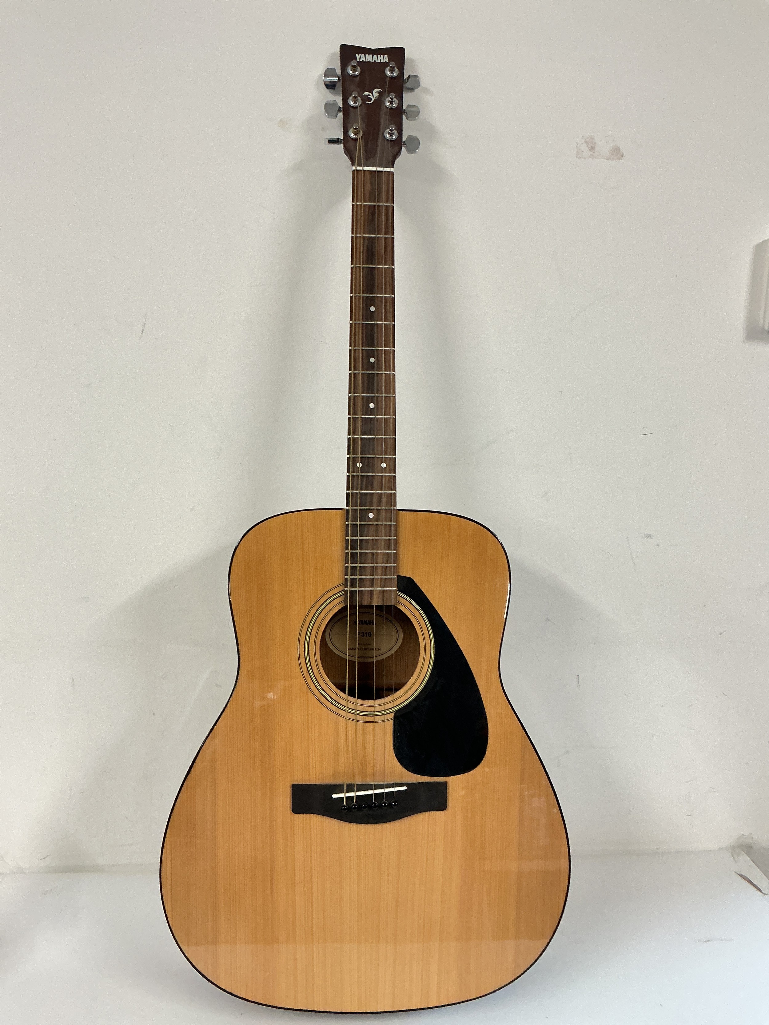 A Yamaha F310 acoustic guitar with retail box.