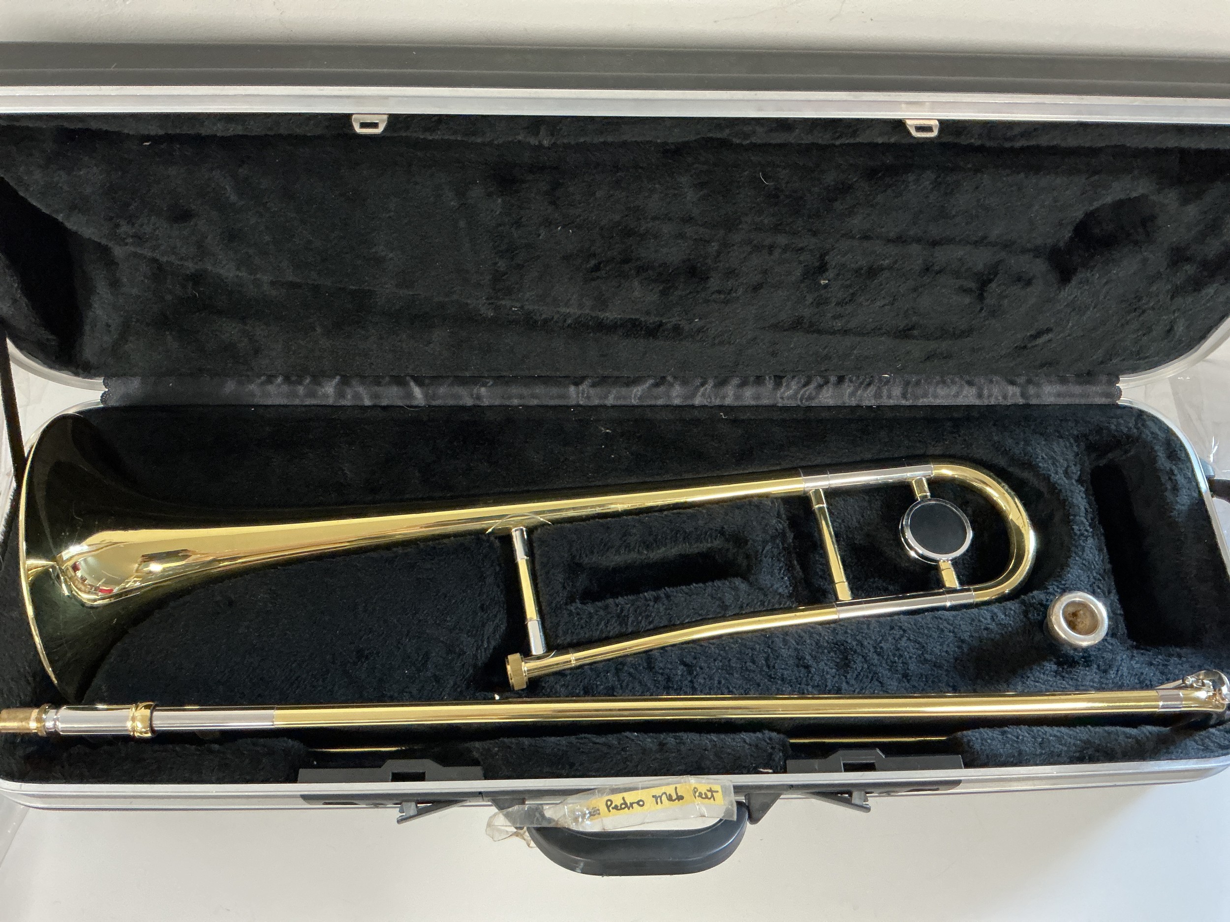A cased trombone with an Earlham mouthpiece.