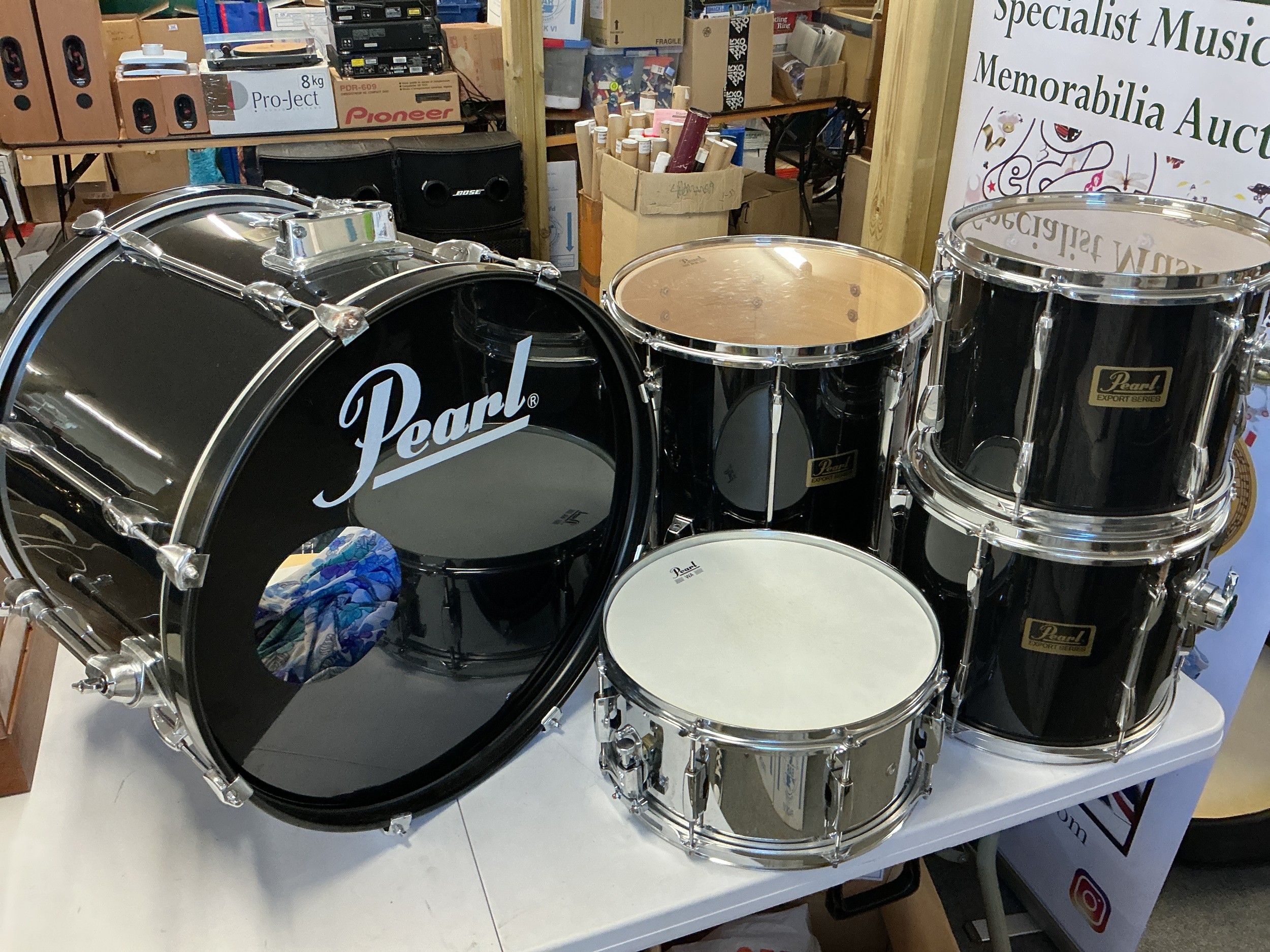 A set of Pearl Export drums comprising bass drum, snare, floor tom and two rack toms. Comes with Protection Racket cases. No cymbals or hardware.