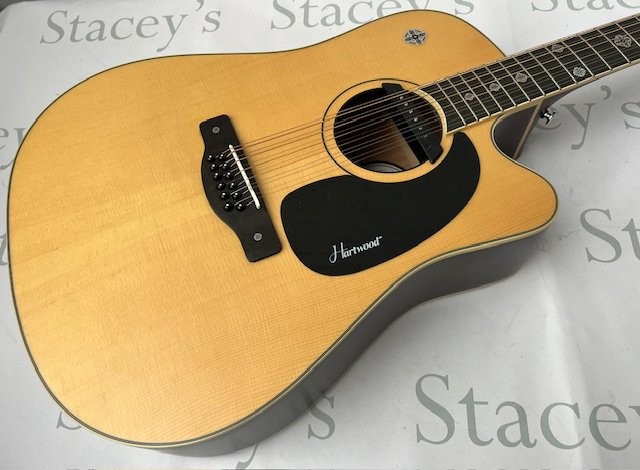 A Hartwood Villanelle 12" string Acoustic Guitar with pickup and cutaway and Celtic cross fret markers. As new in original box.