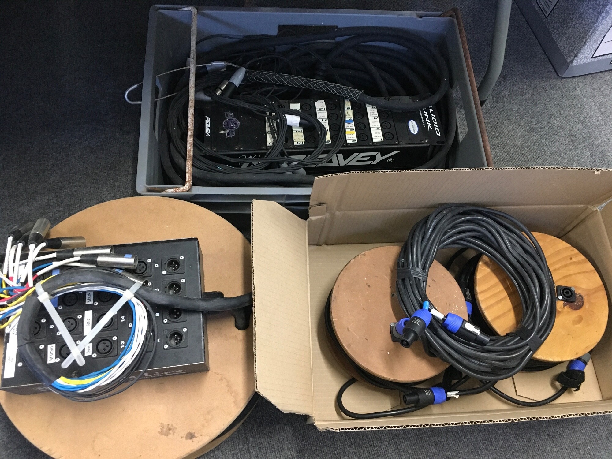 A collection of studio/live equipment comprising a stage box, Peavey audio link, various heavy duty leads etc.