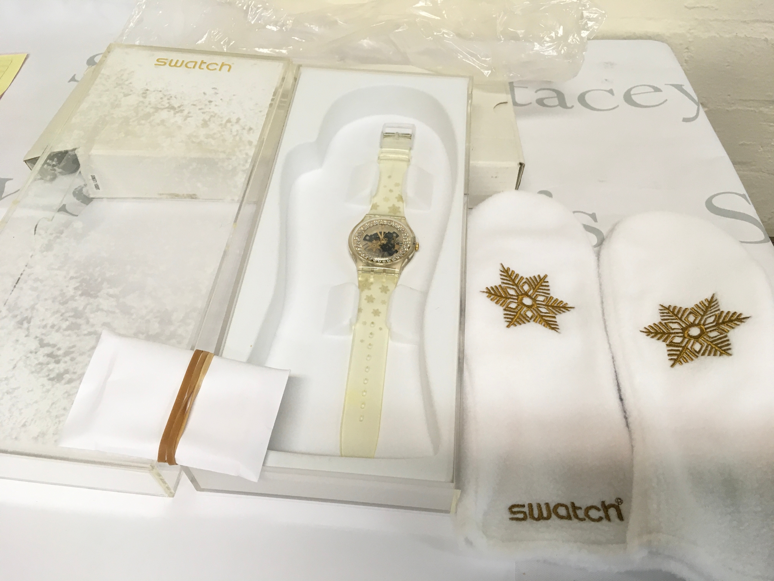 This is a Swatch Snow Your Time Away special edition watch from 2010. Skeletonized dial with a golden rim and crystals, packaged with matching white fleece mittens. A limited edition watch, with only 9,999 pieces produced.