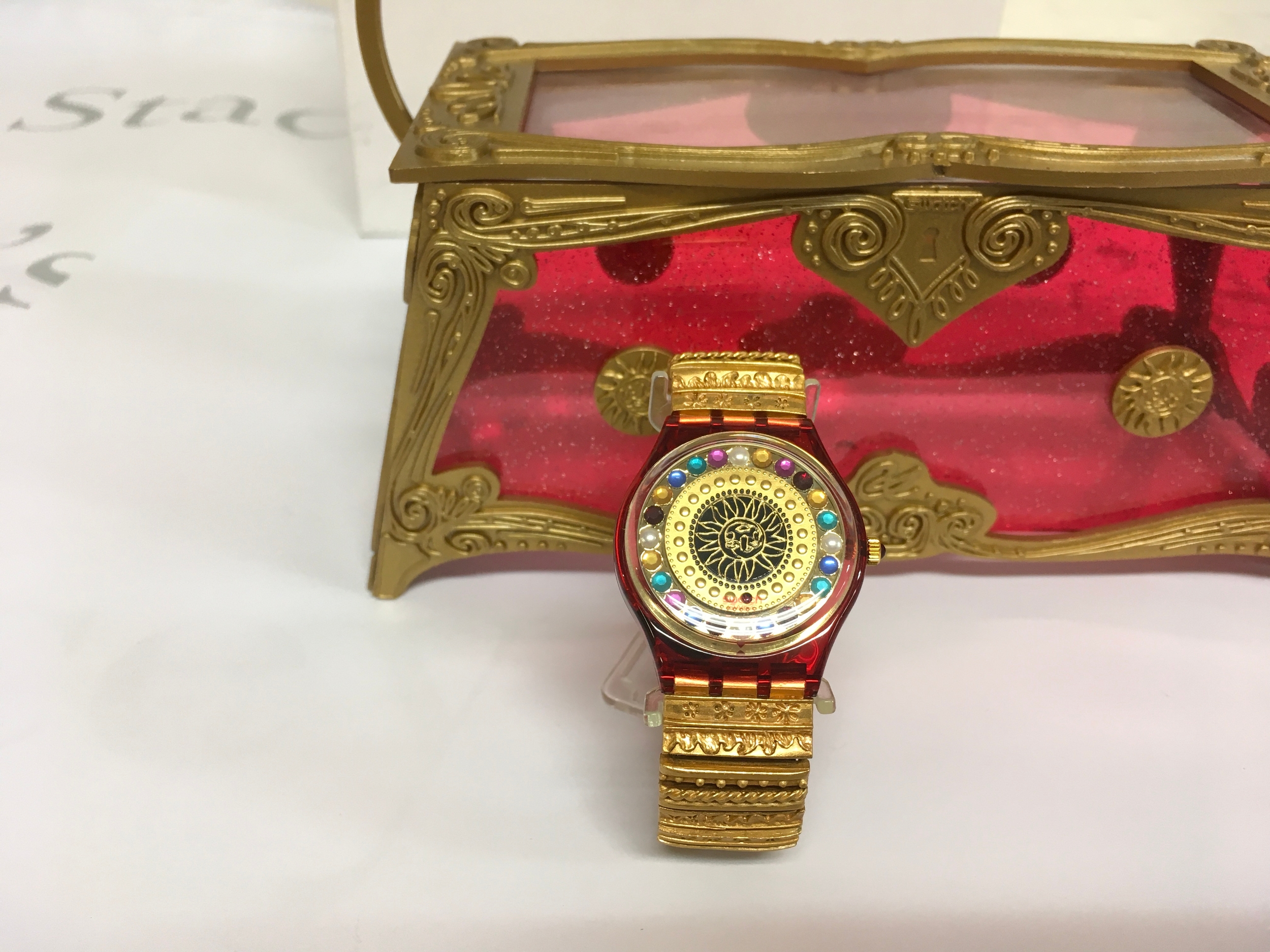 1994 limited edition Swatch watch designed by Christian Lacroix, housed in a special handbag-shaped presentation case. It is a quartz watch limited to 22,222 units worldwide, featuring a heavily constructed flex metal band.