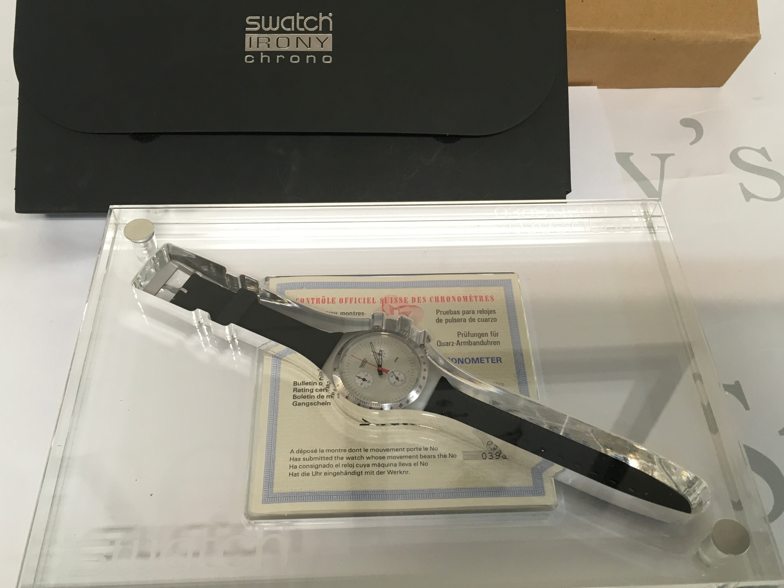 Swatch Irony Chrono "Time Cut" watch. This limited edition timepiece was released in 1995 with only 1,500 units produced worldwide. The watch features a metal case, a quartz movement, and is presented in a unique clear plastic display case. The set includes original paperwork, specifically a chronometer rating certificate