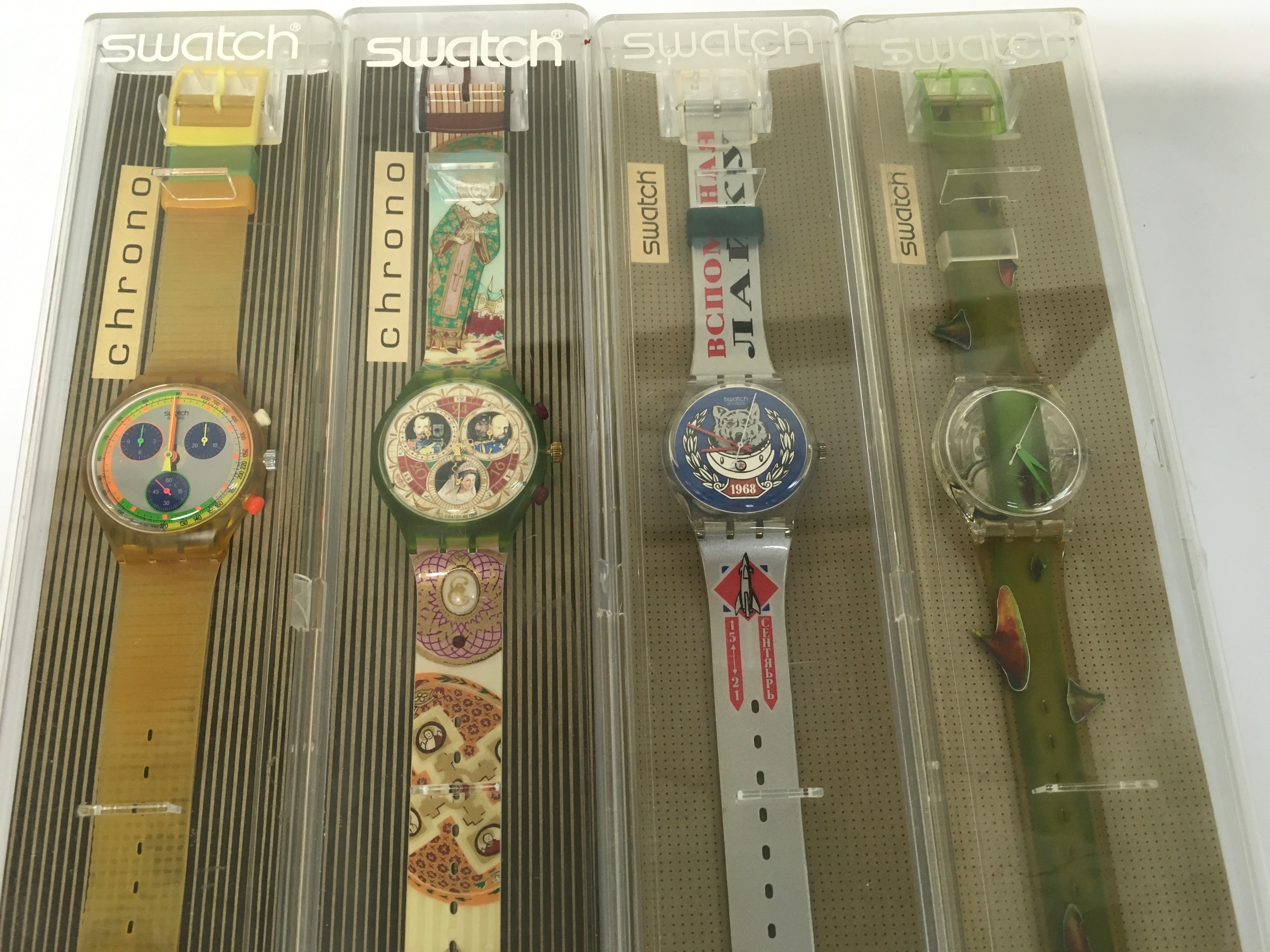 Vintage Swatch watches from the 1990s include models like the "Russian Treasury" chronograph. The watches feature distinct artistic designs and are in their original packaging
