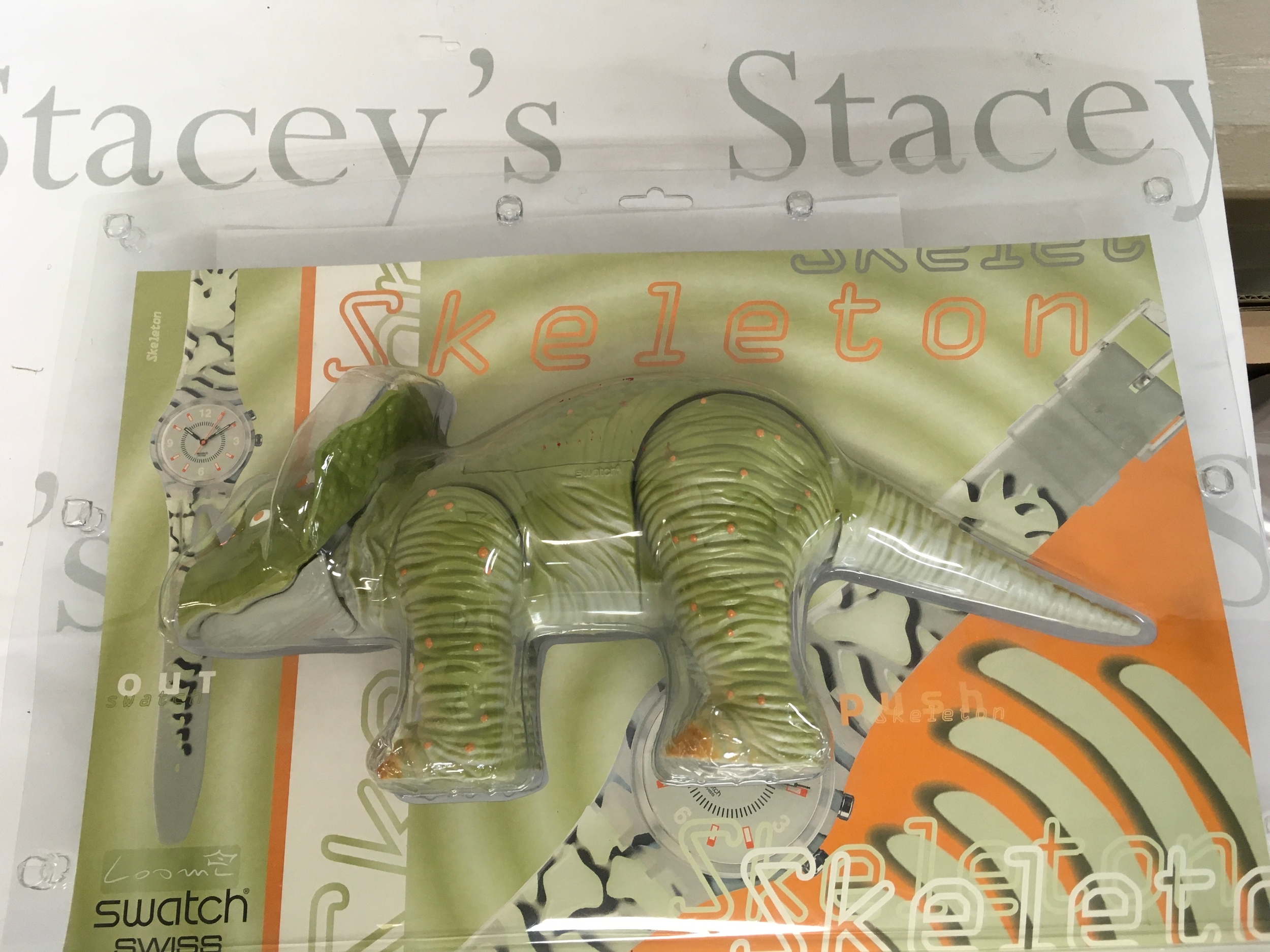rare Swatch Gent Loomi Special "Skeleton" (GK911) from the year 2000. The set includes a watch paired with a green triceratops dinosaur case in original packaging.