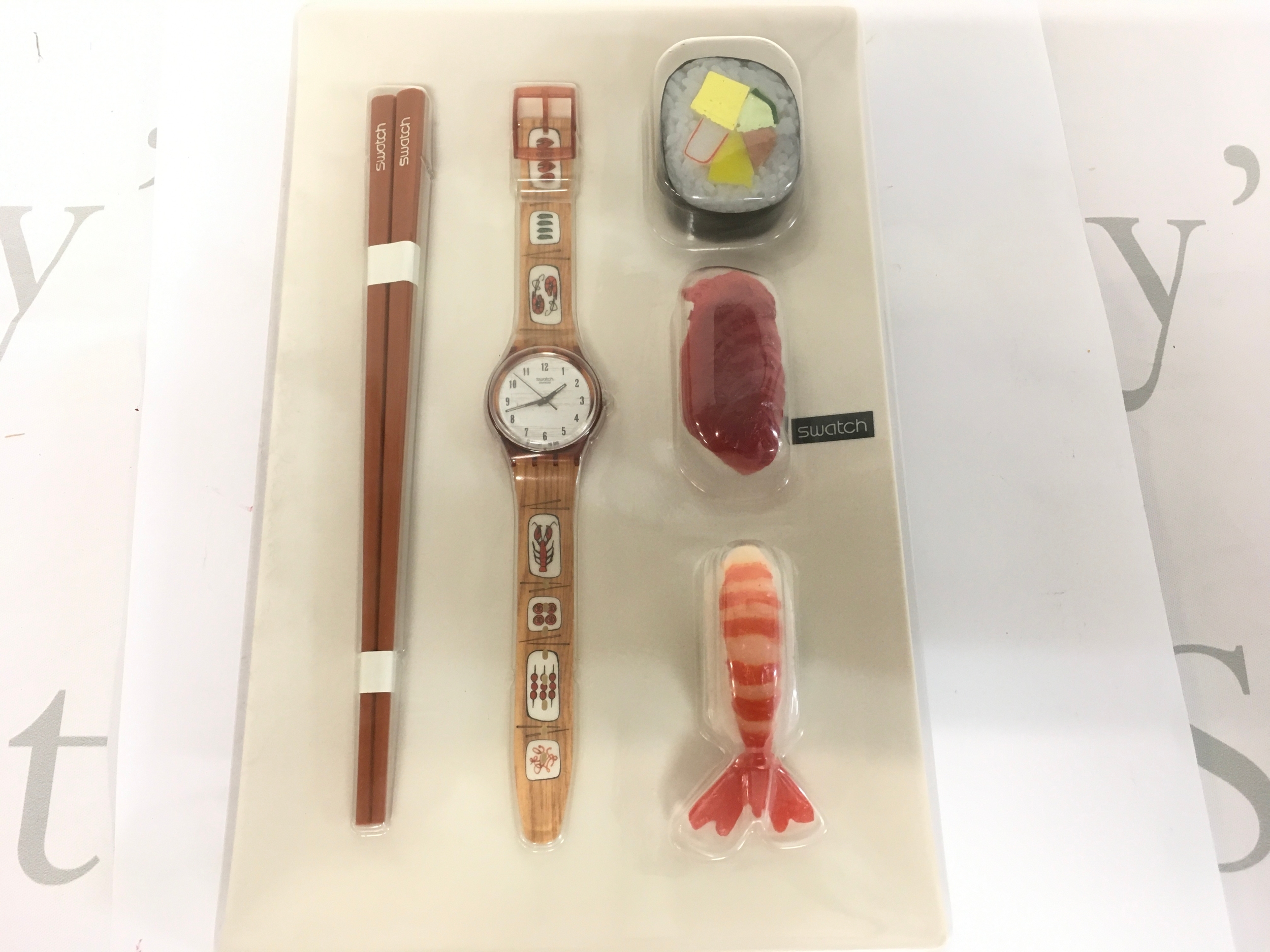 A Swatch "Hors D'Oeuvre" GF112 watch from 2001, featuring a sushi-themed strap design complete with packaging and magnets.