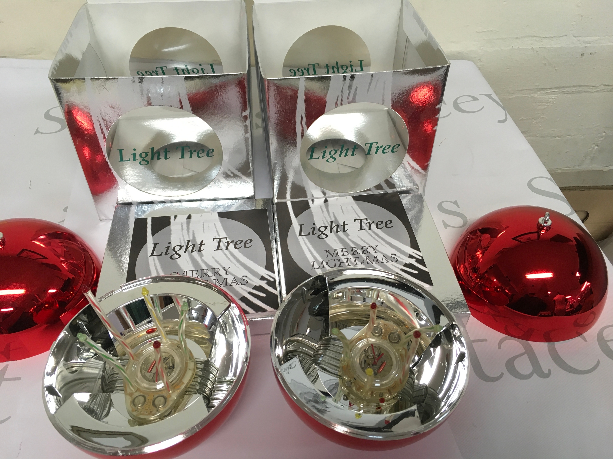 Two 1996 Swatch "Light Tree" Christmas Special (model GZ152), a limited edition set housed in a red ornament-shaped case. Only 20,000 units of this specific model were released worldwide. Comes with packaging,
