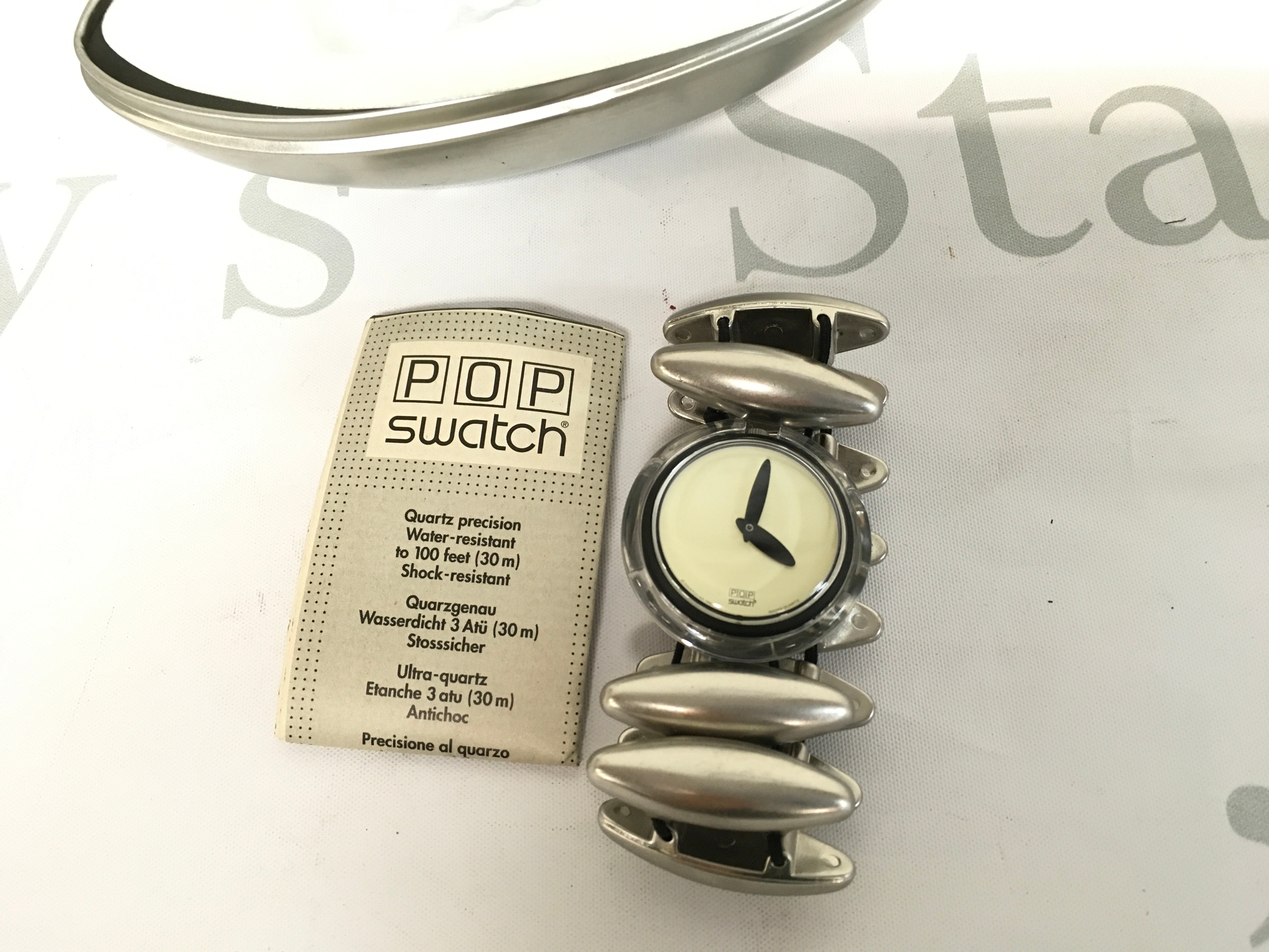 vintage 1997 or 1998 Pop Swatch "Neanda" model (PMB116) featuring a distinctive silver-tone flexible expansion band