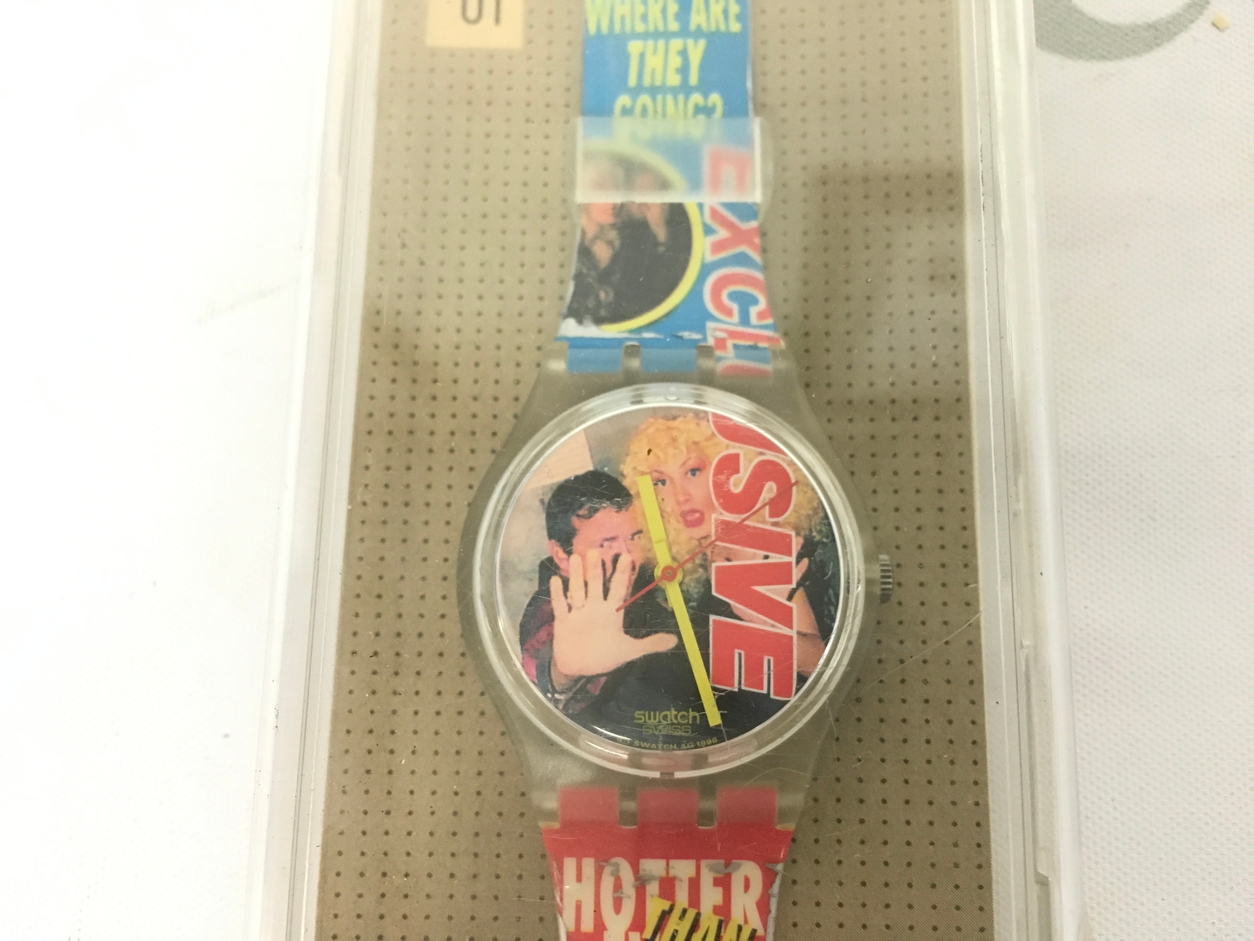 1997 Swatch Gent "Never Seen Before" (model GK258) featuring tabloid-style paparazzi headlines on the strap.