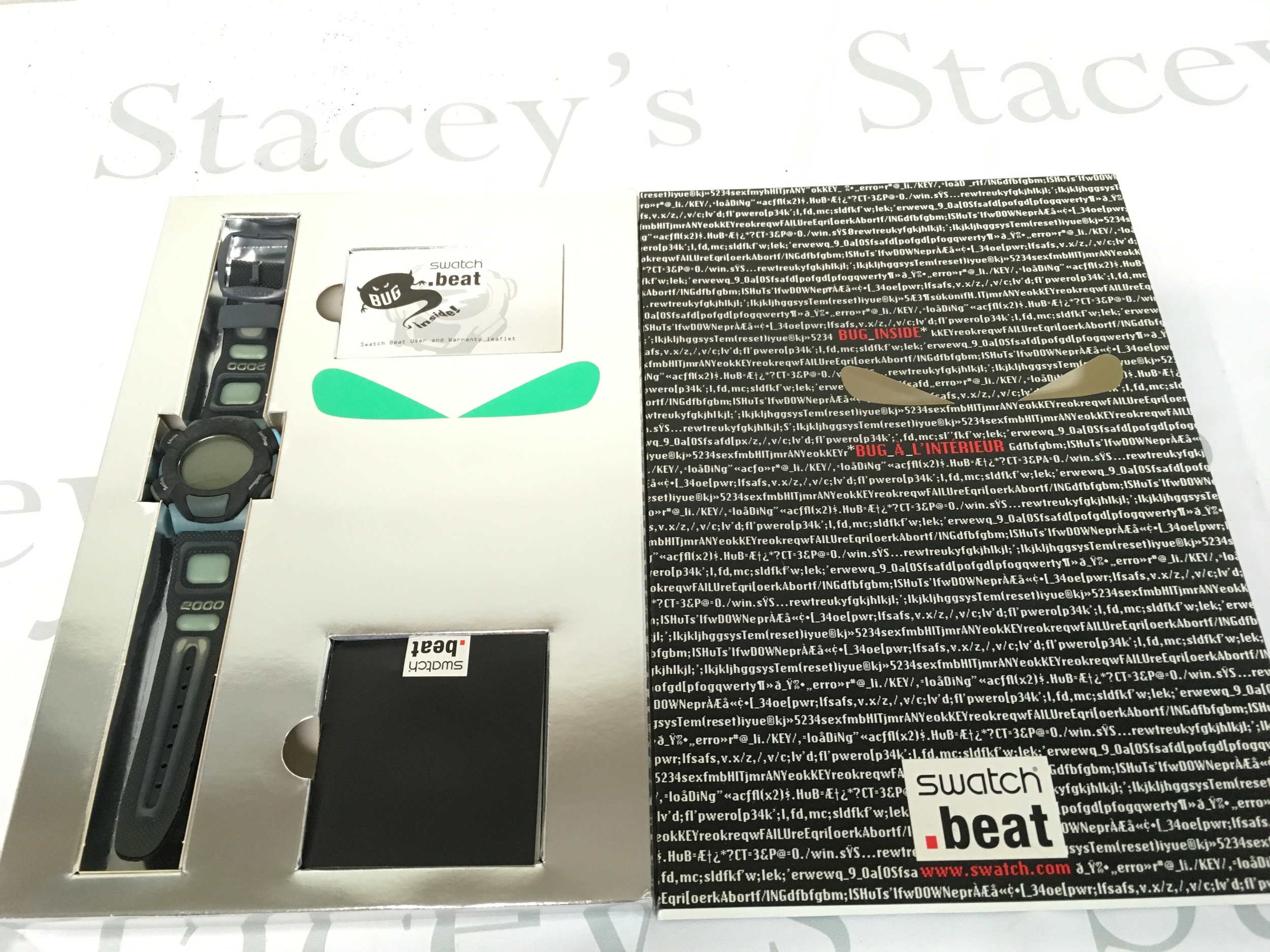 Swatch Beat SQZ103 "Still Working" watch from the 1999 Millennium collection features a dark grey strap and a digital display.