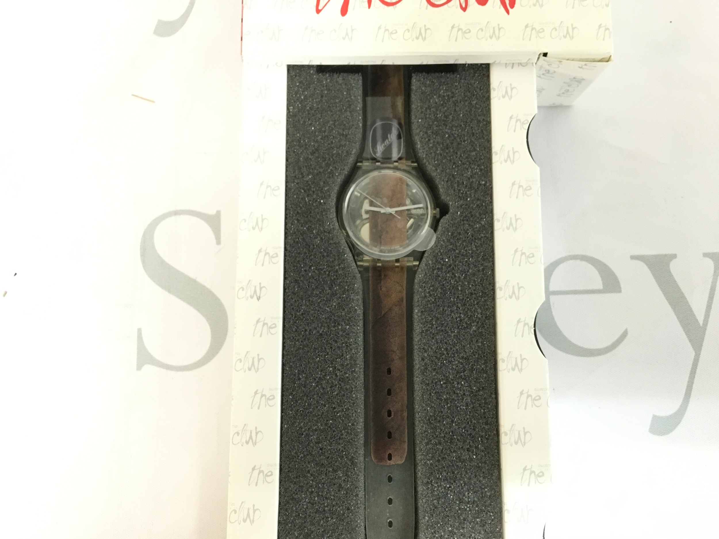 vintage Swatch Standard Gents "Cigar" (GK250)wristwatch from approximately 1995-1997. The watch features a unique design with a full-size cigar image running from the strap through the dial.