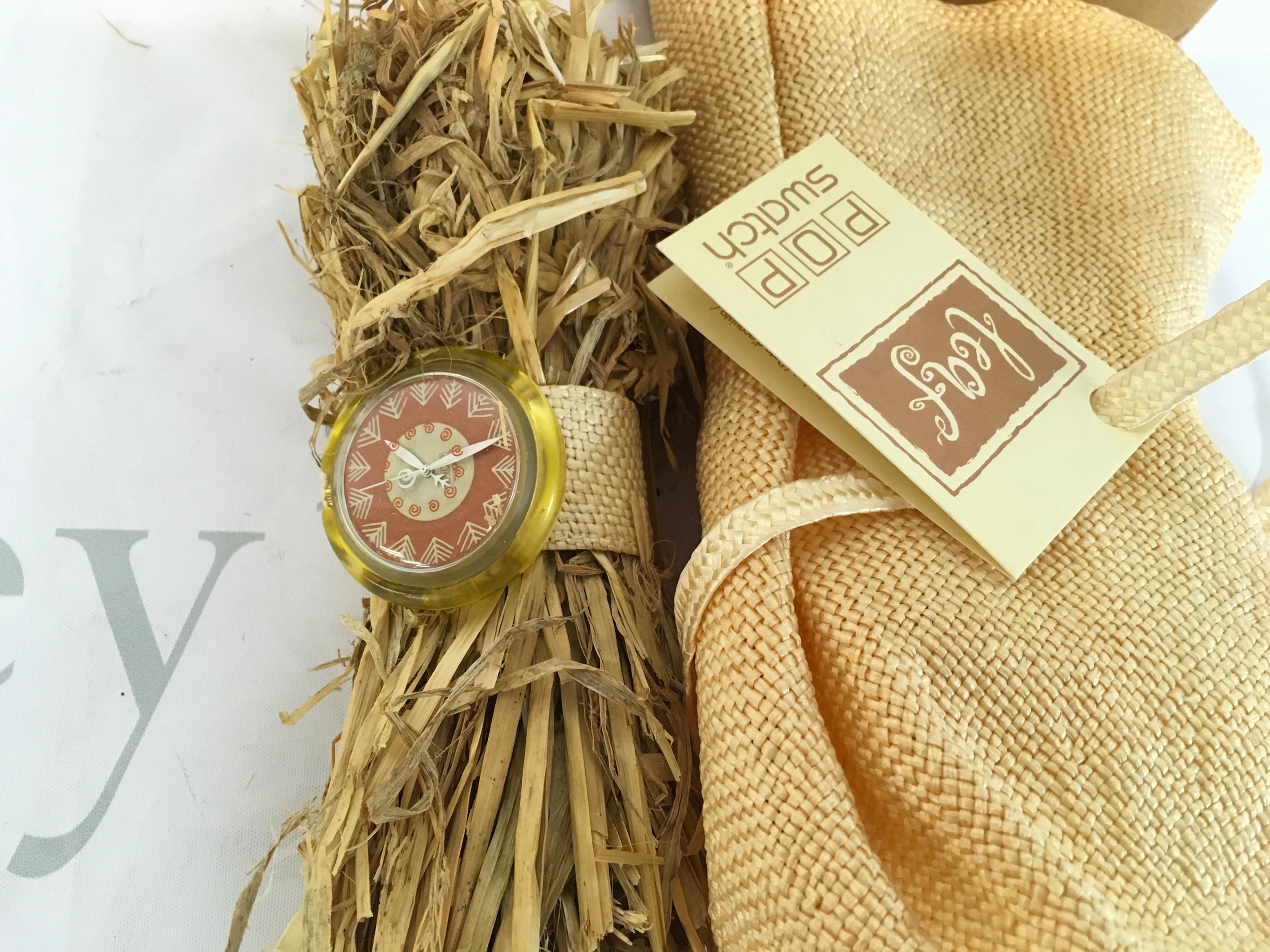 vintage 1994 "Leaf" Pop Swatch special edition watch, model number PWZ108. It was designed by Stephane Plassier and features a unique braided straw bracelet. The watch set includes a matching straw pouch for storage. It was released as a limited edition, with only 33,333 pieces produced