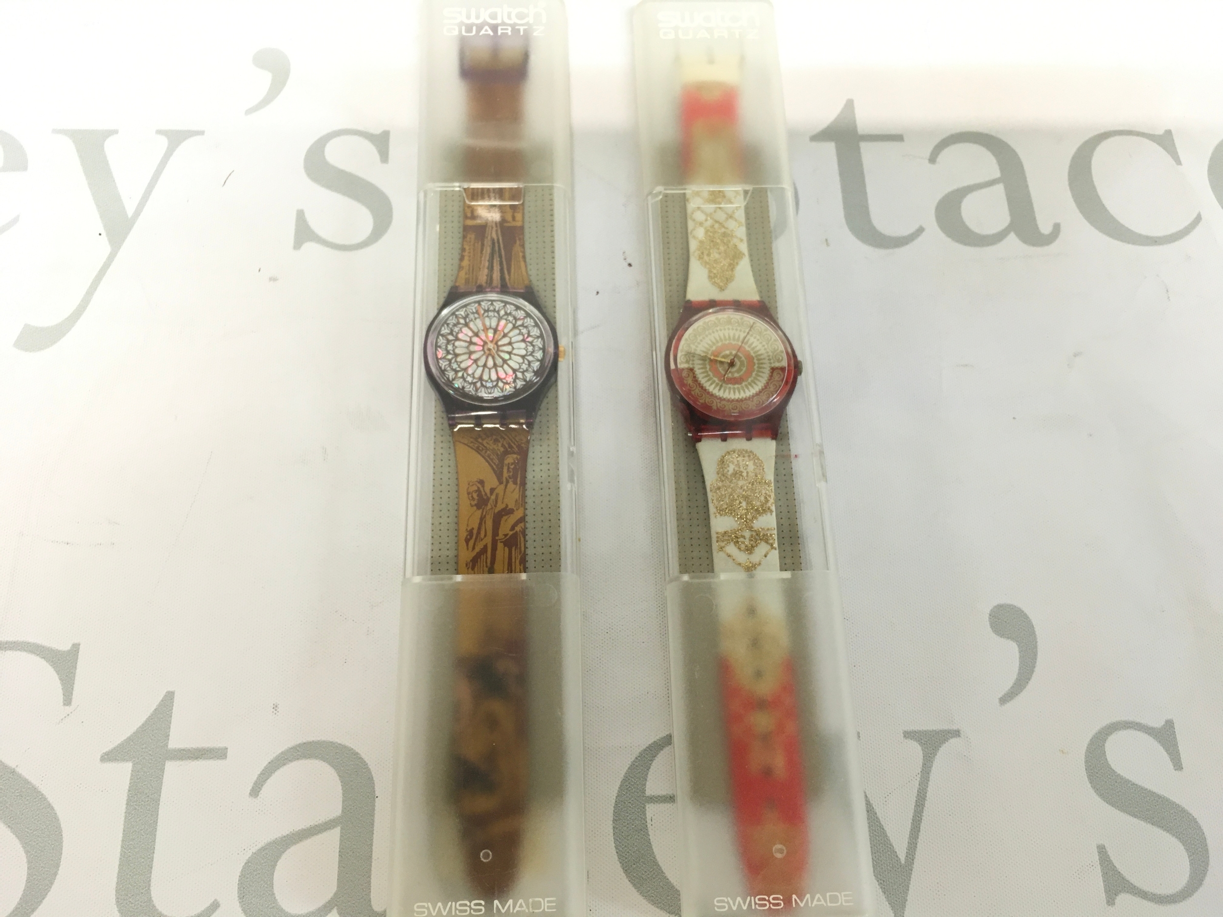 Two vintage watches including vintage 1994 Swatch "Quasimodo" (GV108) watch featuring a Notre Dame stained glass design on the dial.