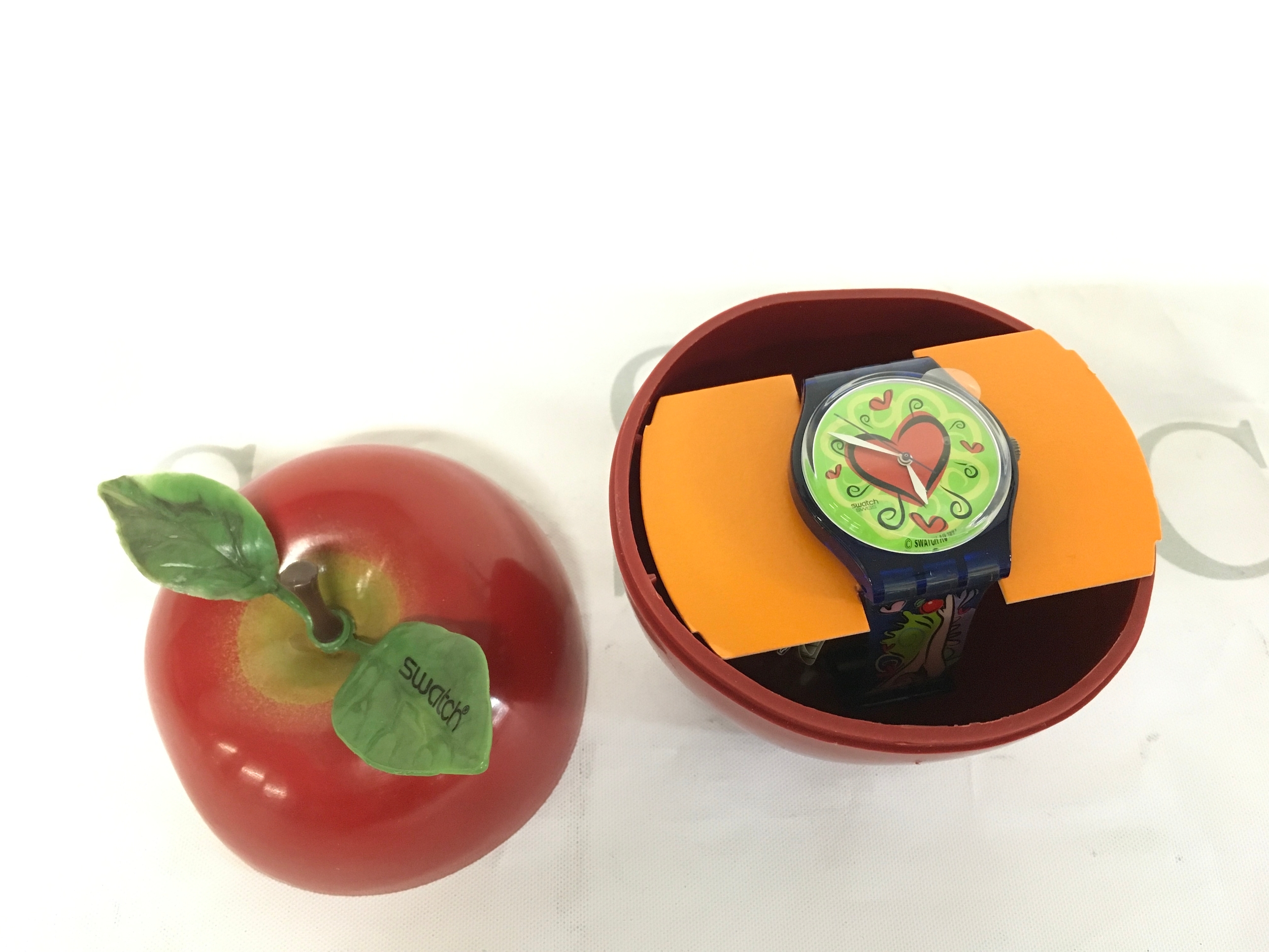 1997 Swatch "Love Bite" (GN176) Gent Originals watch, featured in a special Valentine's Day packaging. The watch dial and strap showcase a colorful, romantic design with a red heart motif.