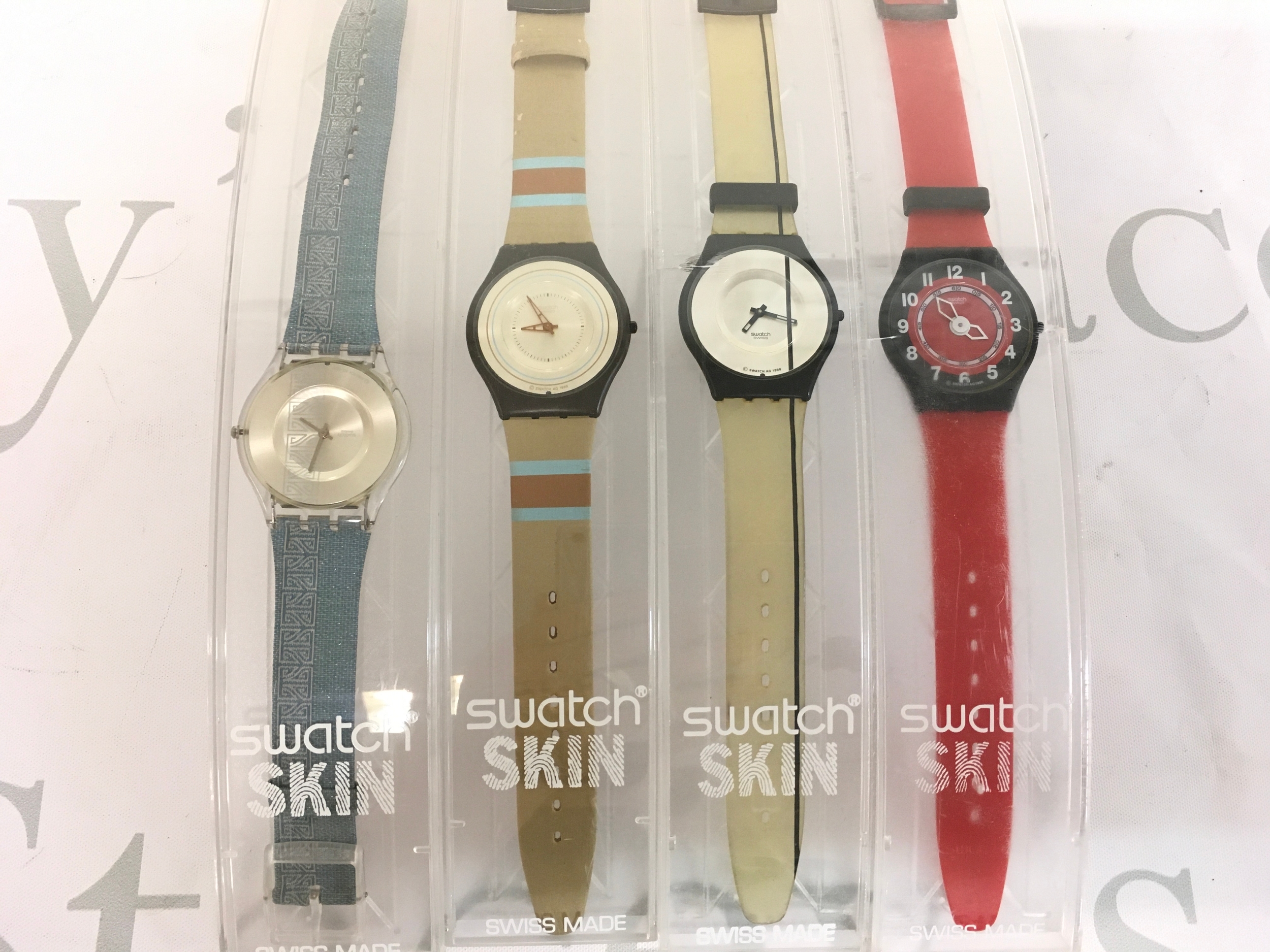 Collection of four Swatch Skin watches of various design.
