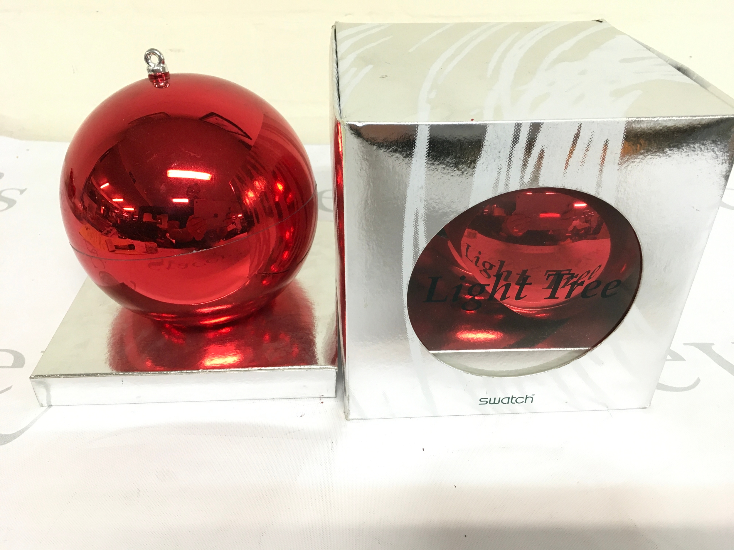 Two 1996 Swatch "Light Tree" Christmas Special (model GZ152), a limited edition set housed in a red ornament-shaped case. Only 20,000 units of this specific model were released worldwide.