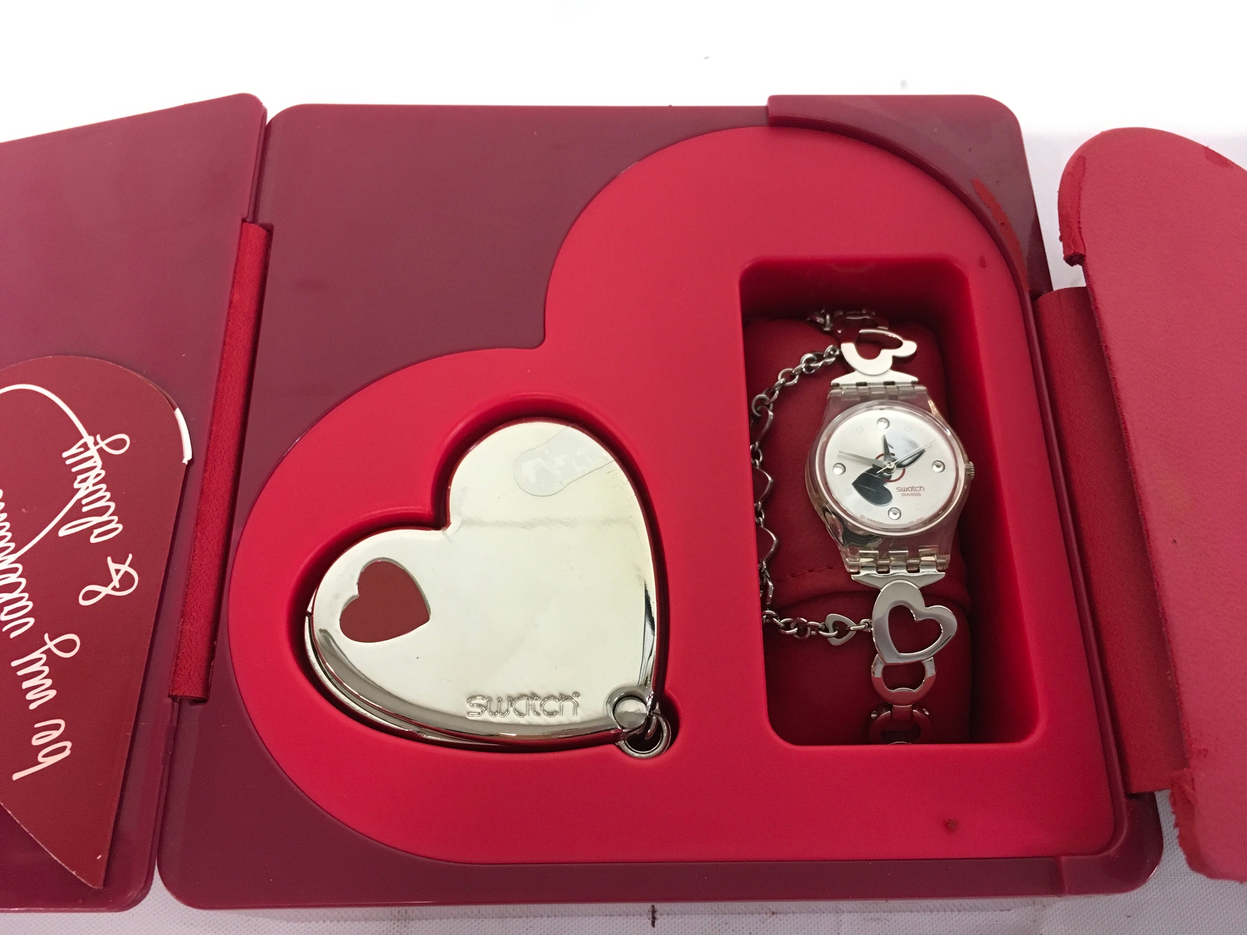 Swatch You're My Love (LK307G) watch from the 2009/2010 Valentine's collection, featuring heart-shaped charms and a silver dial