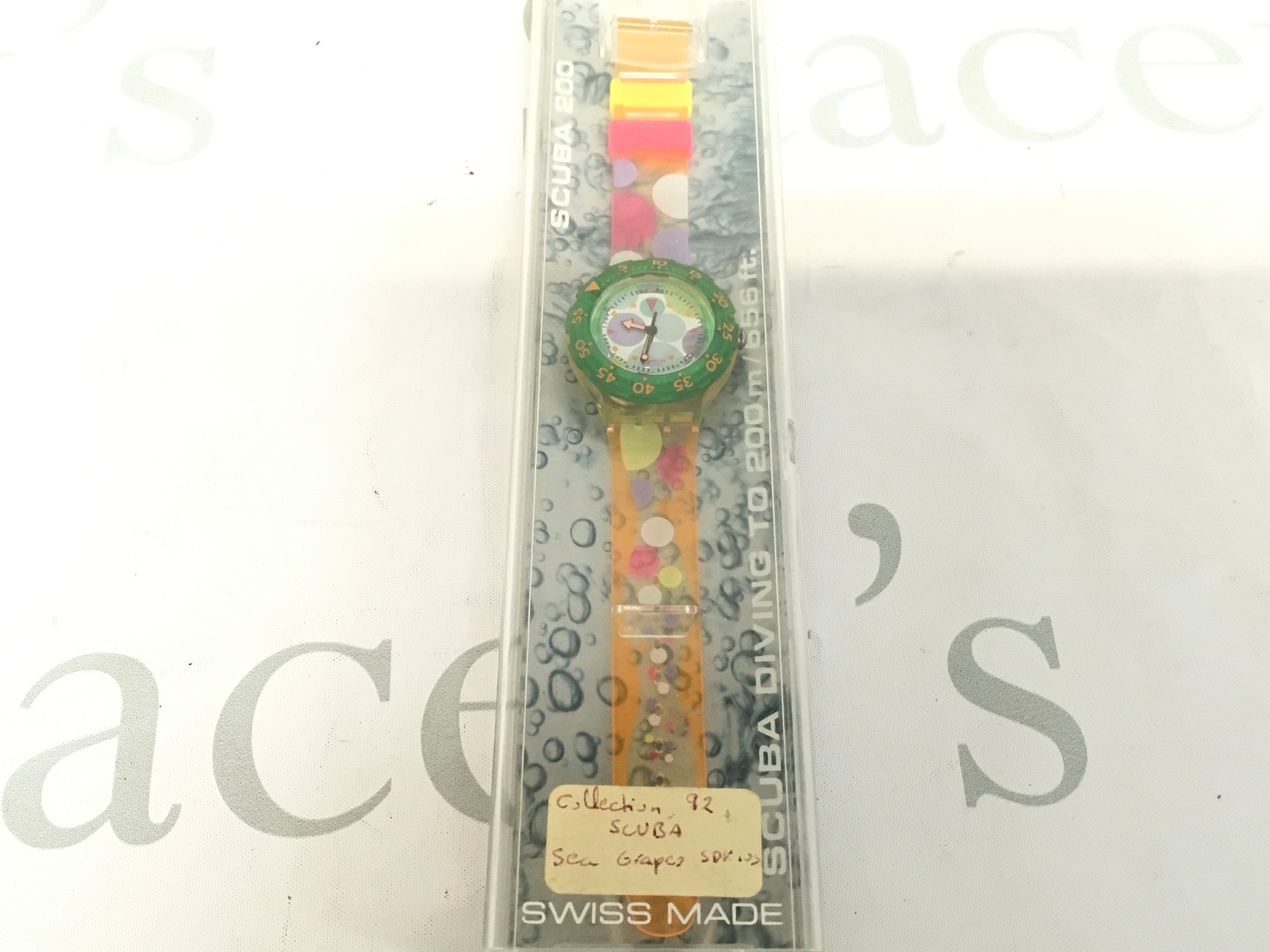 Swatch Scuba 200 "Sea Grapes" (SDK105) watch from 1991, featuring a colorful dial and a transparent strap with multicolored confetti dots.