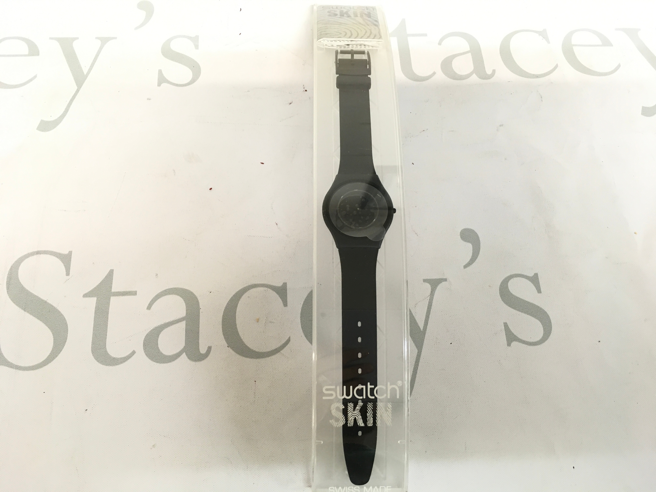 Swatch Caricia Negra Bioceramic watch features a slim, all-black design with a biosourced strap and bioceramic case