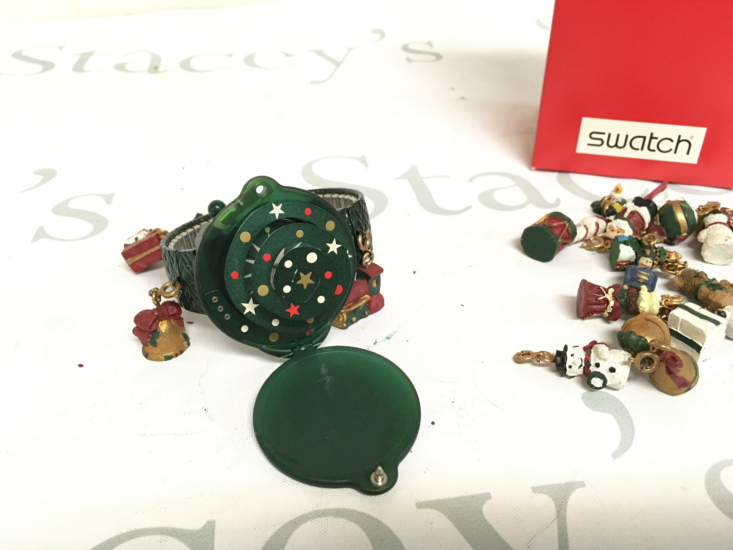 1997 Swatch "Seasons Greetings" advent calendar watch, model GZ900. It is a limited edition featuring a green plastic case designed to look like a Christmas tree.
