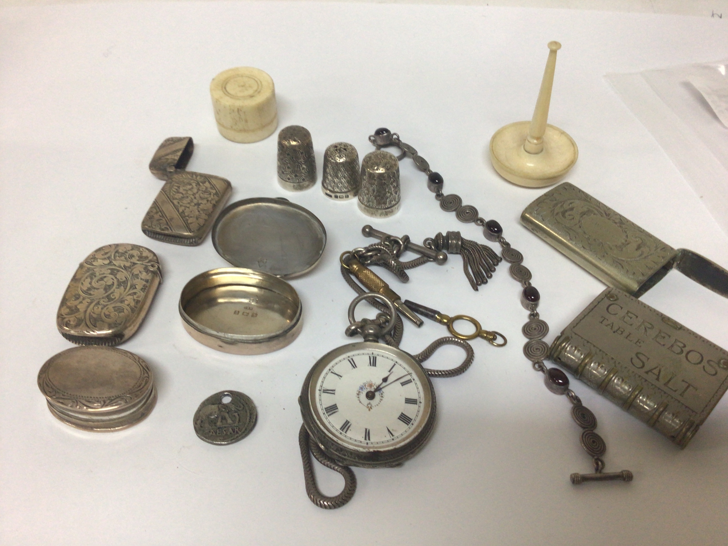  A collection of Silver Vesta cases silver thimbles a silver cased watch vesta cases with business advertising. a silver key wind watch and other oddments. 
