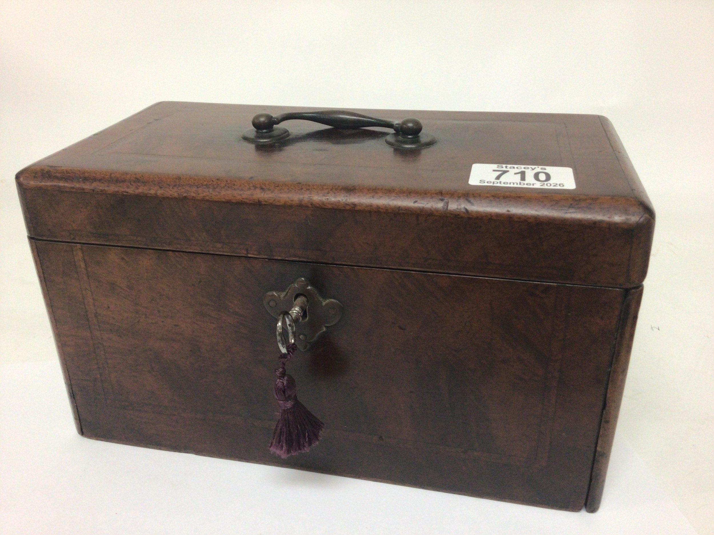 A George III 18th century walnut and feather banded tea caddy of rectangular shape with three compartment the side with a sliding panel and secret compartment.