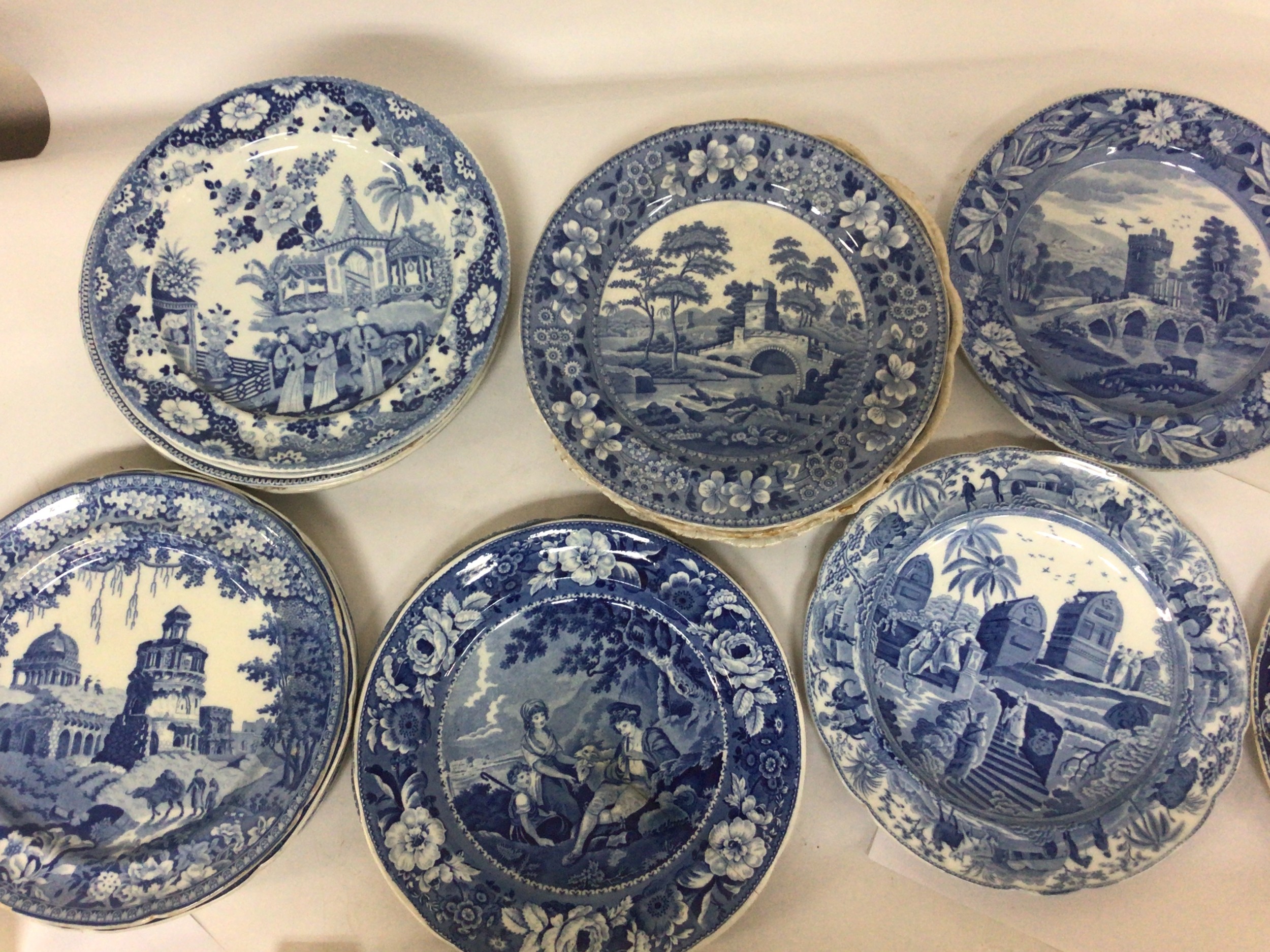 A collection of Victorian ceramics blue and white dinner plates including some decorated with interesting scenes Grand Tour monuments and many others. Some with minor edge chips. 