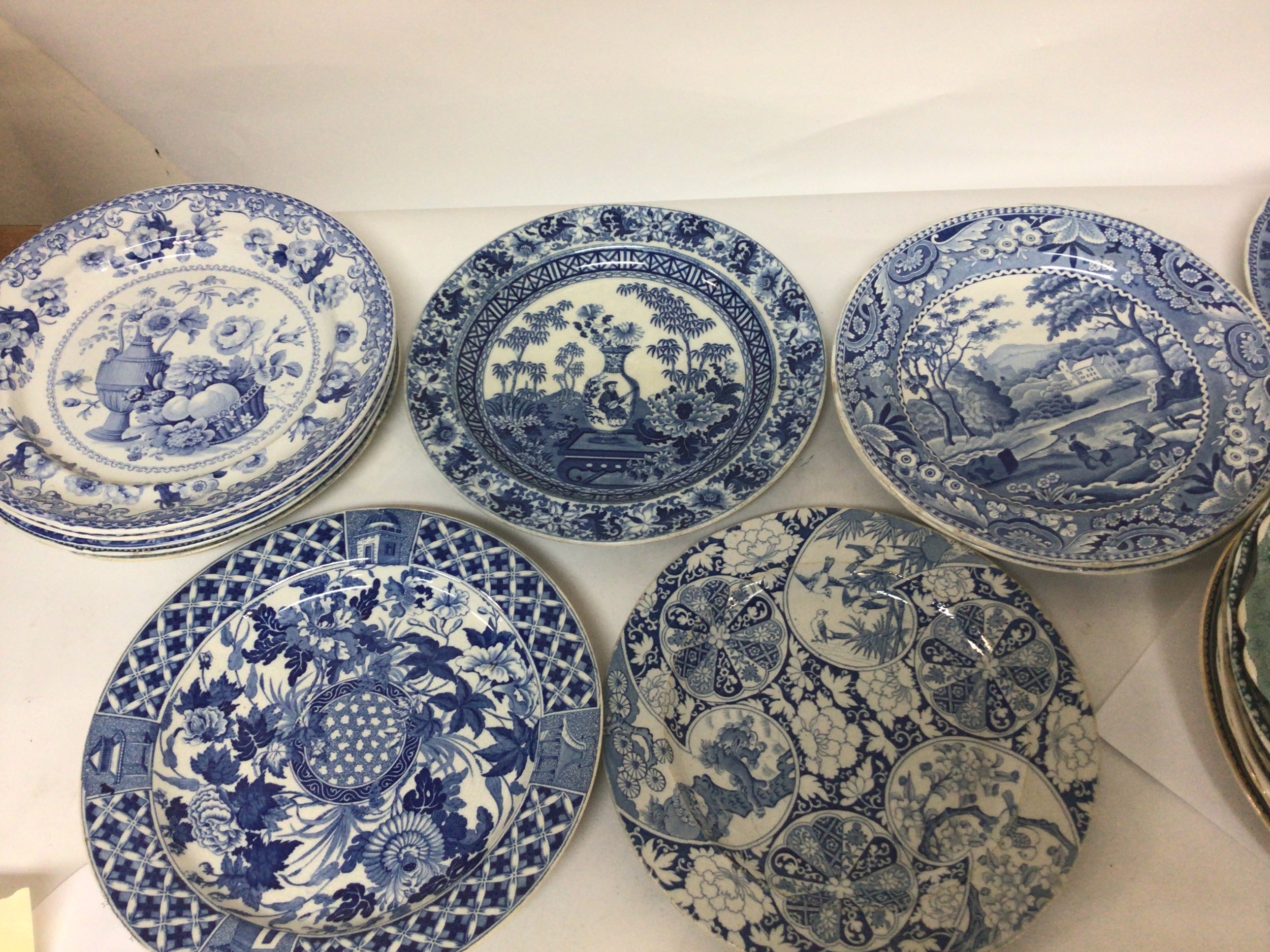  A Collection of Victorian blue and white plates decorated with mixed views including European views Spode and other makers and some green coloured plates 