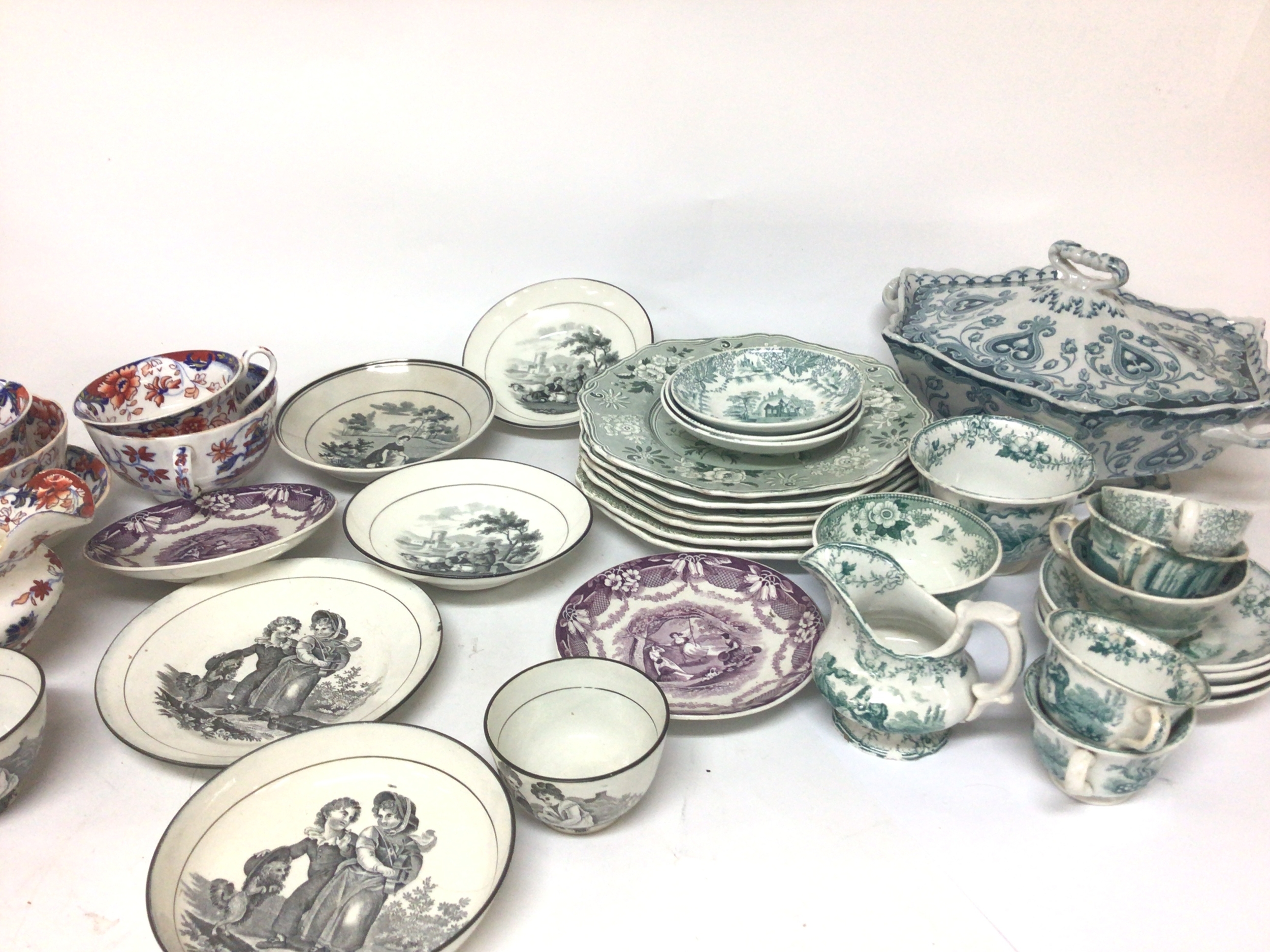  A collection of Victorian ceramics cups saucers and early transfer decorated dishes depicting Victorian children and landscapes. A few cracks and chips. 