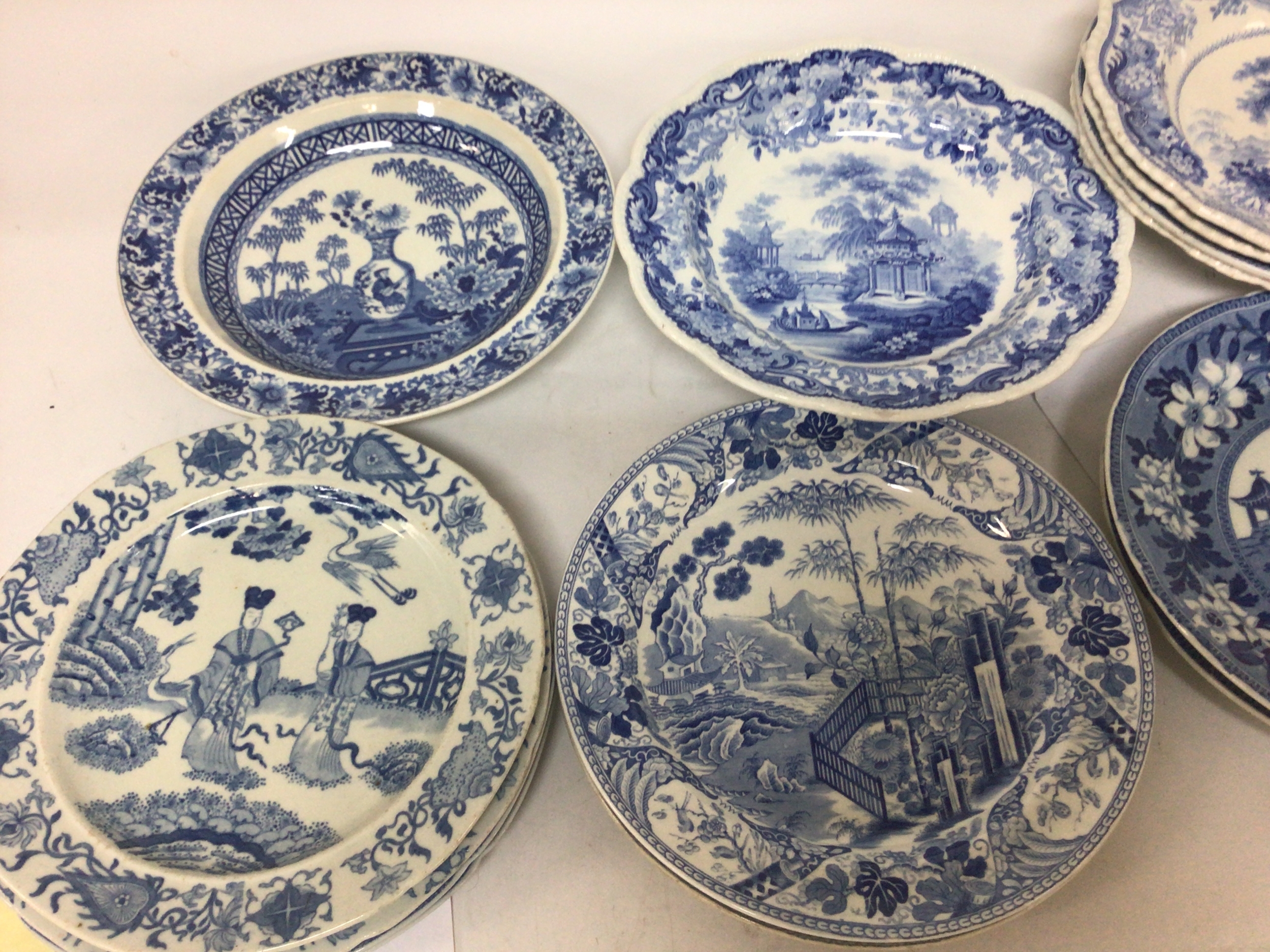A collection of Victorian blue and white dishes and plates decorated with mixed interesting scenes oriental landscapes with elephants views of the grand tour with Roman ruins and others