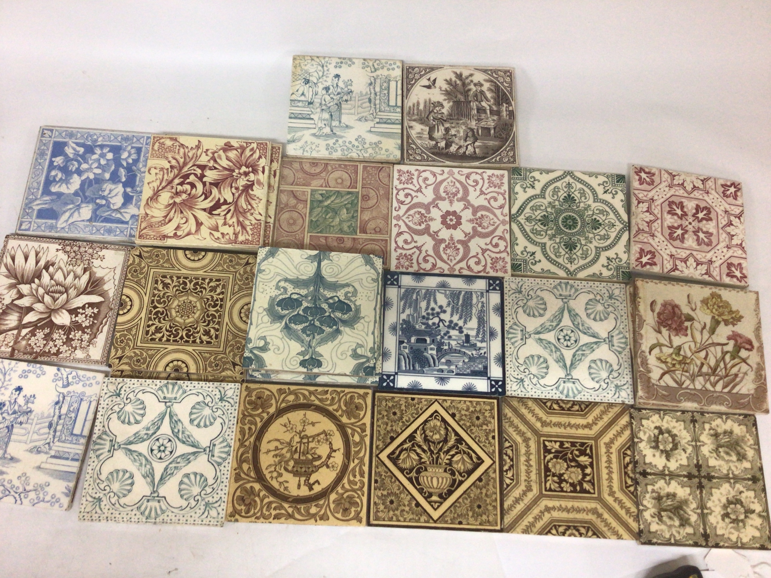 A collection of Victorian patterned tiles including some  Minton tiles with batch and pattern numbers to the reverse including pairs and sets of three and four matching tiles all good condition in keeping with age. 