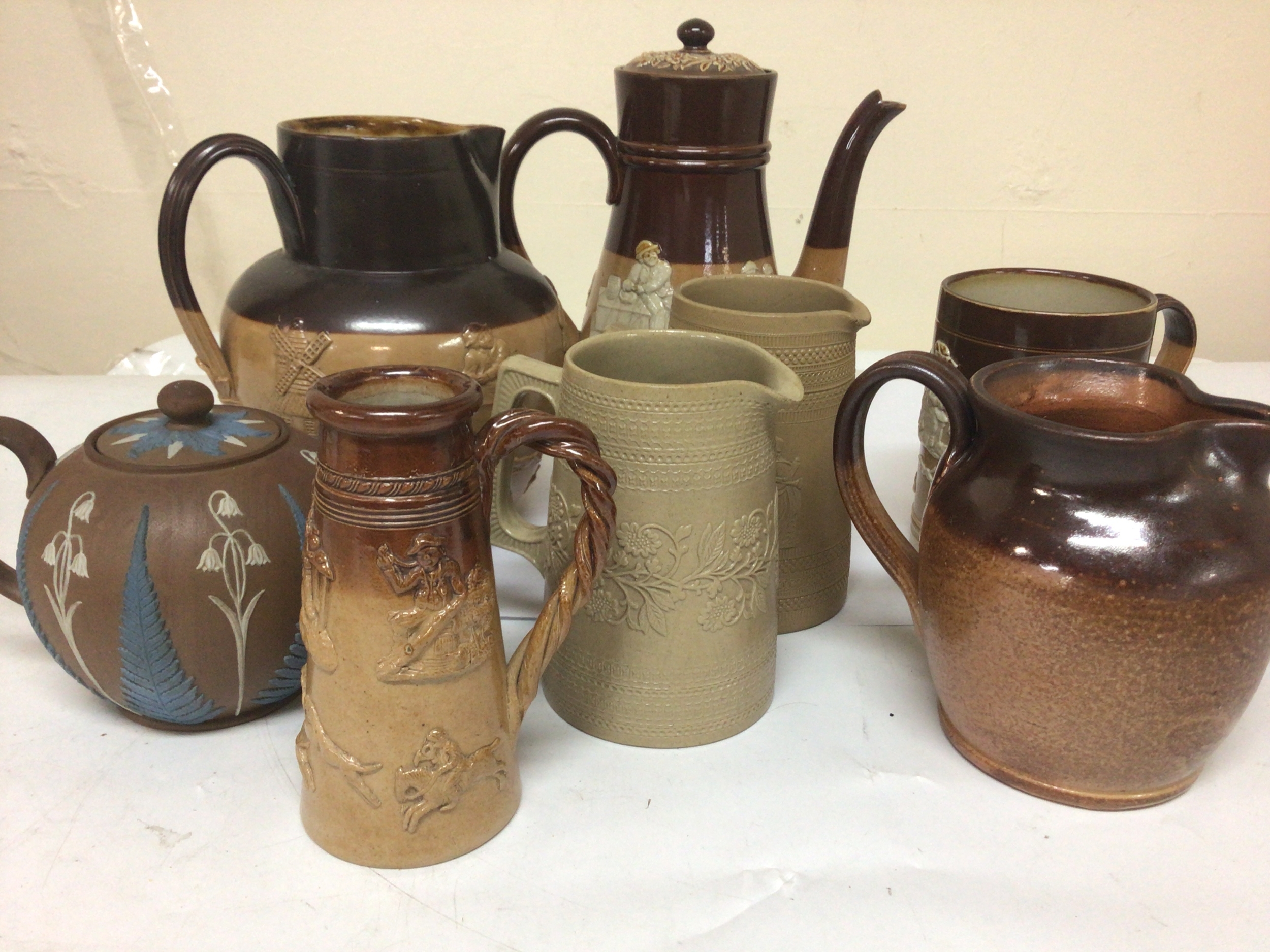  A collection of Lambeth Doulton Victorian stoneware a decorative earthenware tea pot and two Copland Spode stoneware jugs. No Obvious damage. 