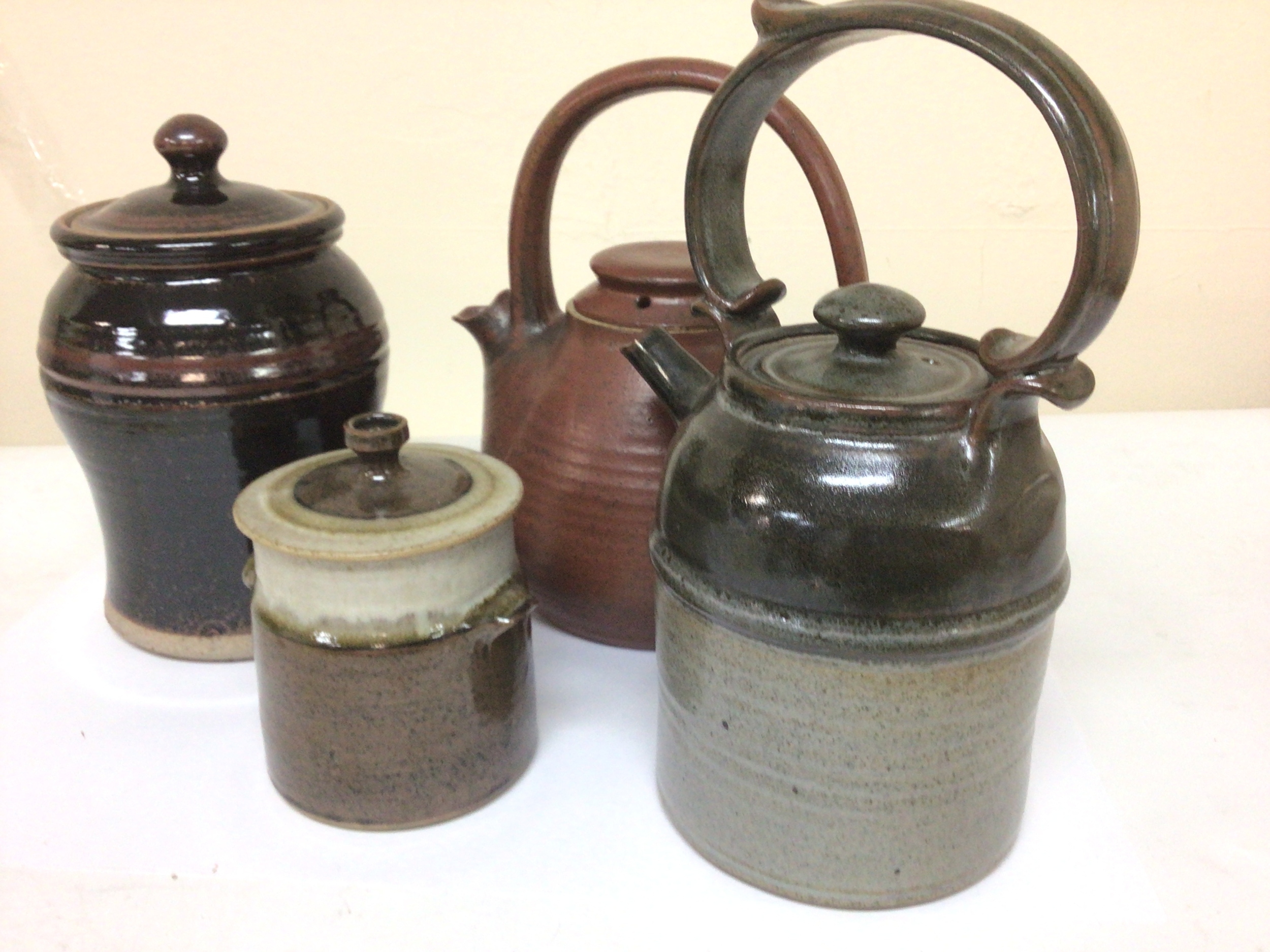  A collection of 20th century Studio Art Pottery two tea pots and two storage jars with underglaze decoration and unidentified artist impress marks no obvious damage maximum Hight 25cm (4) 