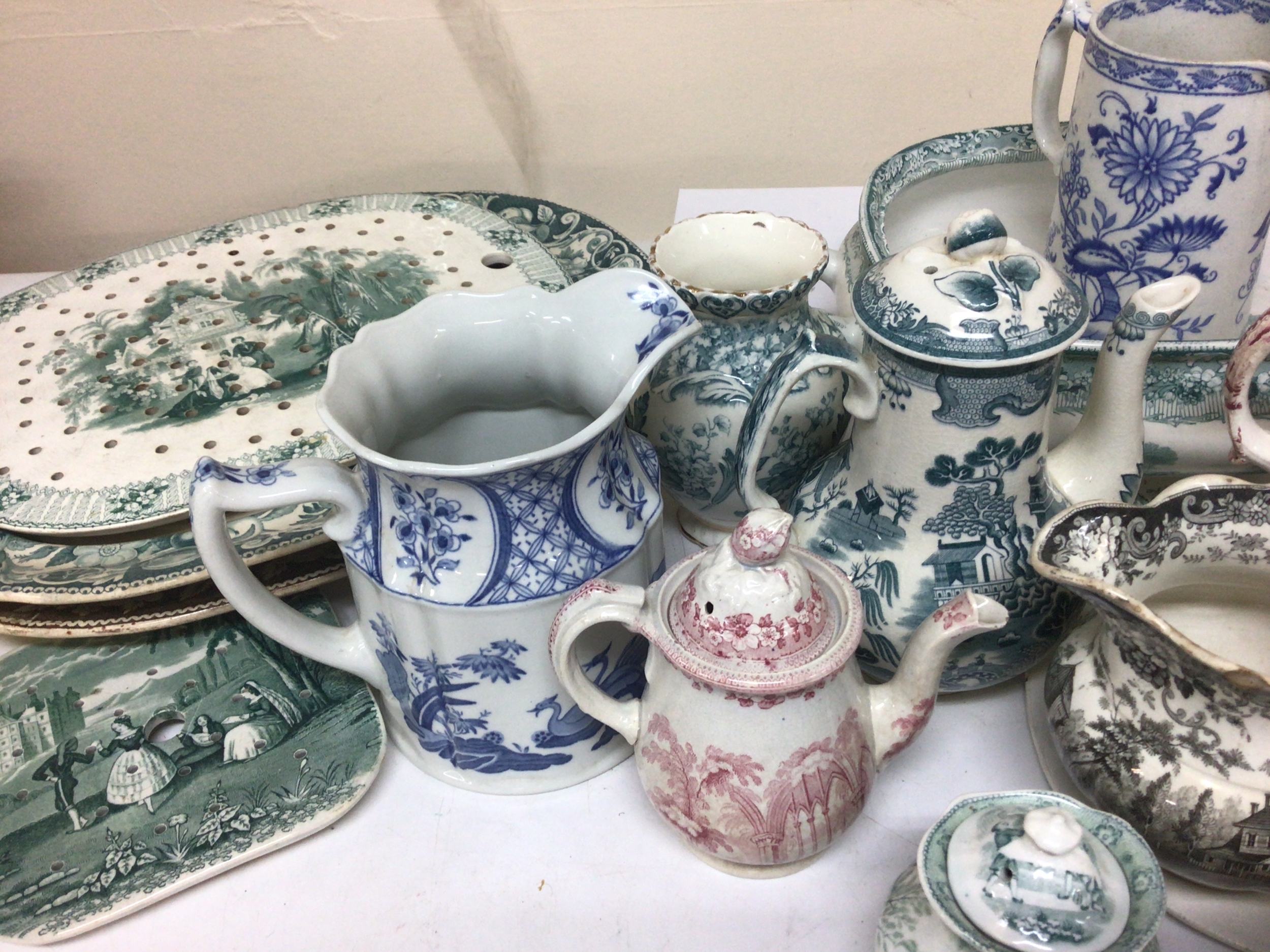 A Collection of Victorian ceramic jugs meat plate and other plate strainers jugs shaped dishes and covers and other ceramics some chips to a few of the jugs otherwise condition I. Keeping with age no obvious damage. 