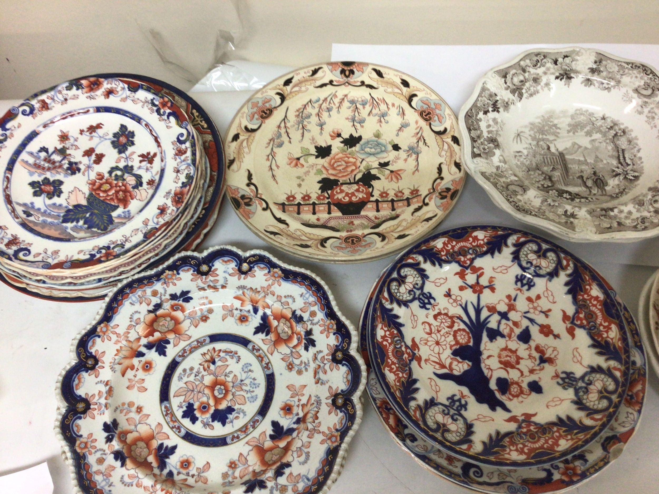  A collection of Victorian polychrome plates some with shaped edges including Royal Crown Derby Ironstone and others. 