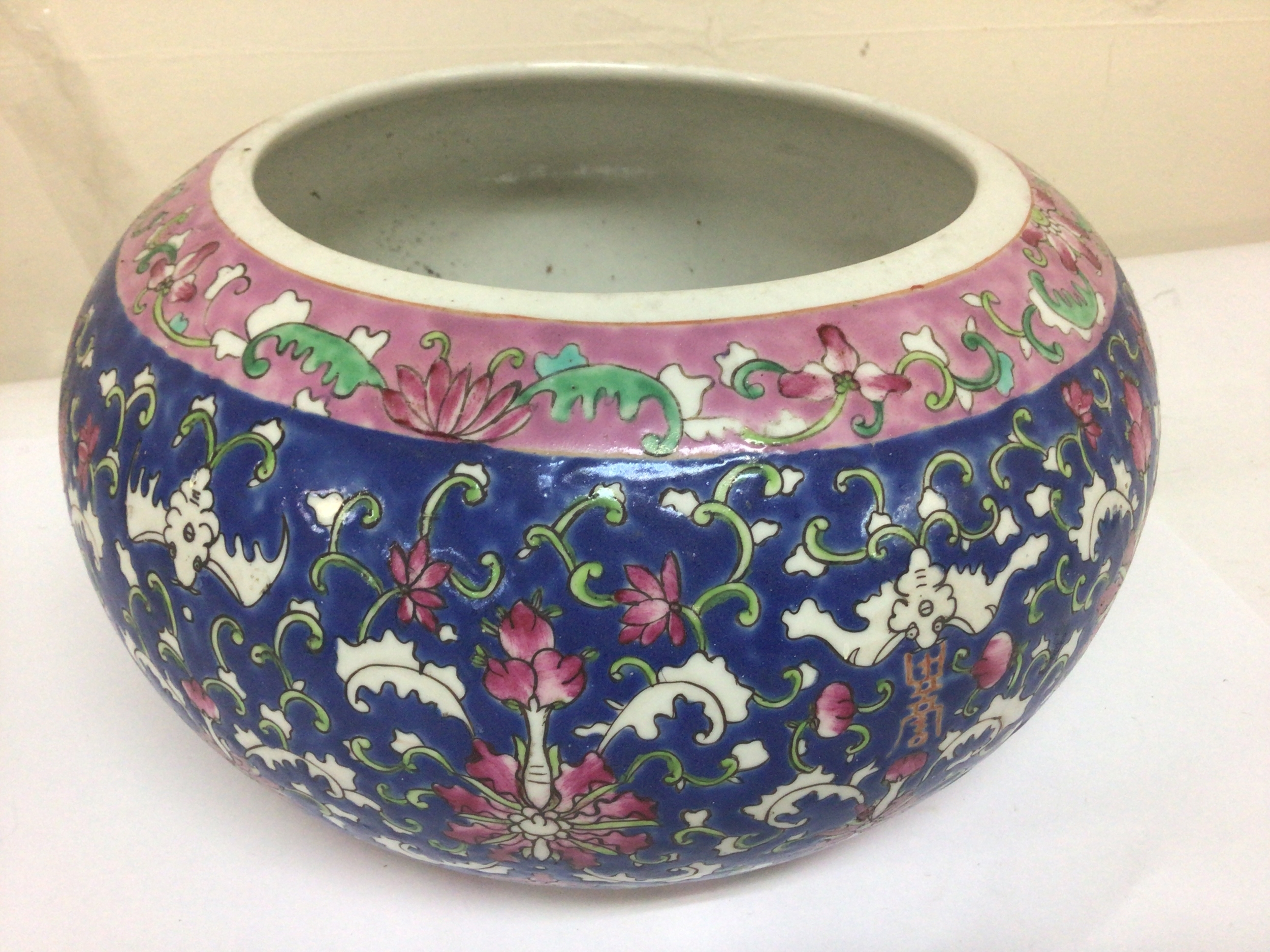  A Chinese porcelain jardiniere polychrome with a repeat pattern Republic period caricature marks in red to the base diameter 30cm no obvious damage. 