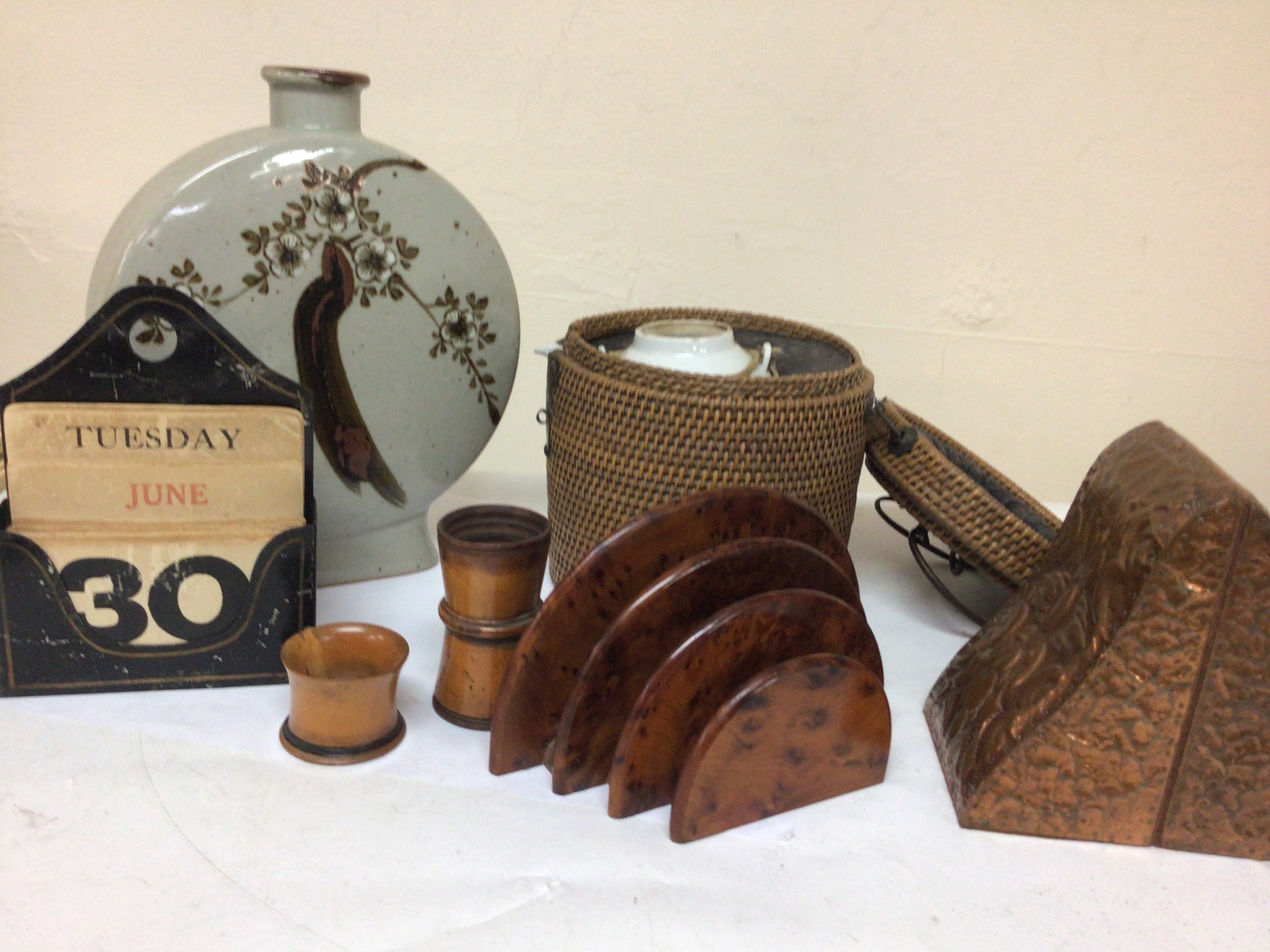 A collection of items comprising copper bookends treen Victorian dice shaker with dice a Chinese tea pot in a wicker case a Contemporary ceramic vase walnut letter rack. 