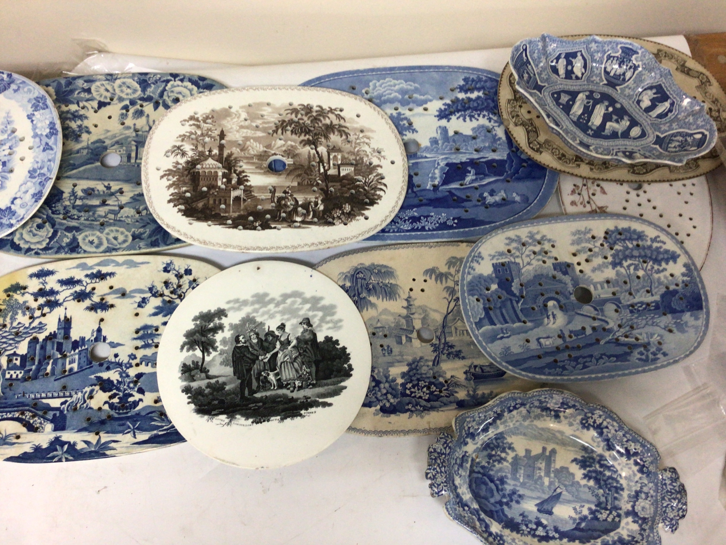  A collection of Victorian meat dish strainers and dishes mainly blue and white with full decoration with landscape views and others most in good condition. 