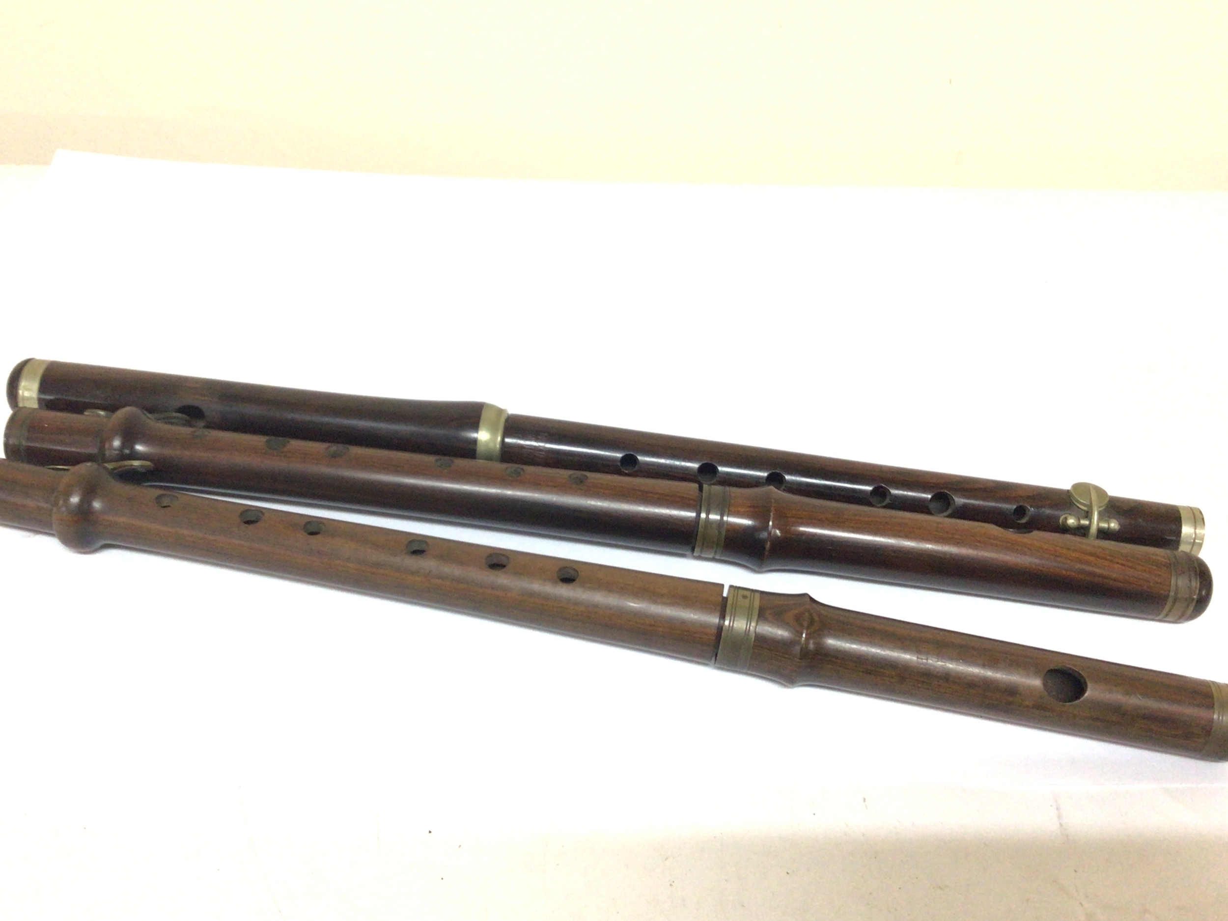  Three Victorian Cocuswood and Rosewood flutes with makers names Boosey & Hawkes.  