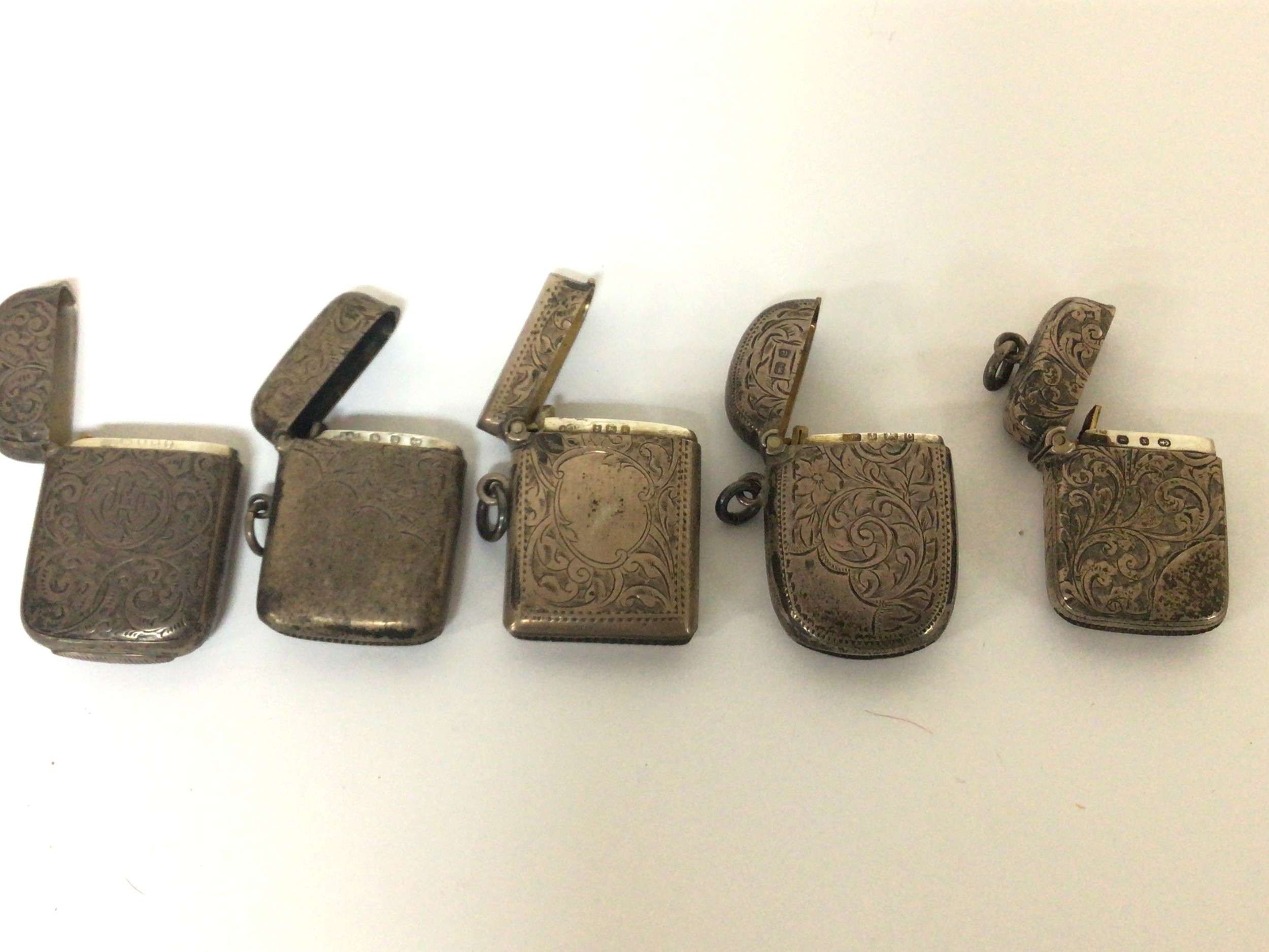 Five Victorian and Edwardian silver Vesta case with engraved scroll decoration. (5)