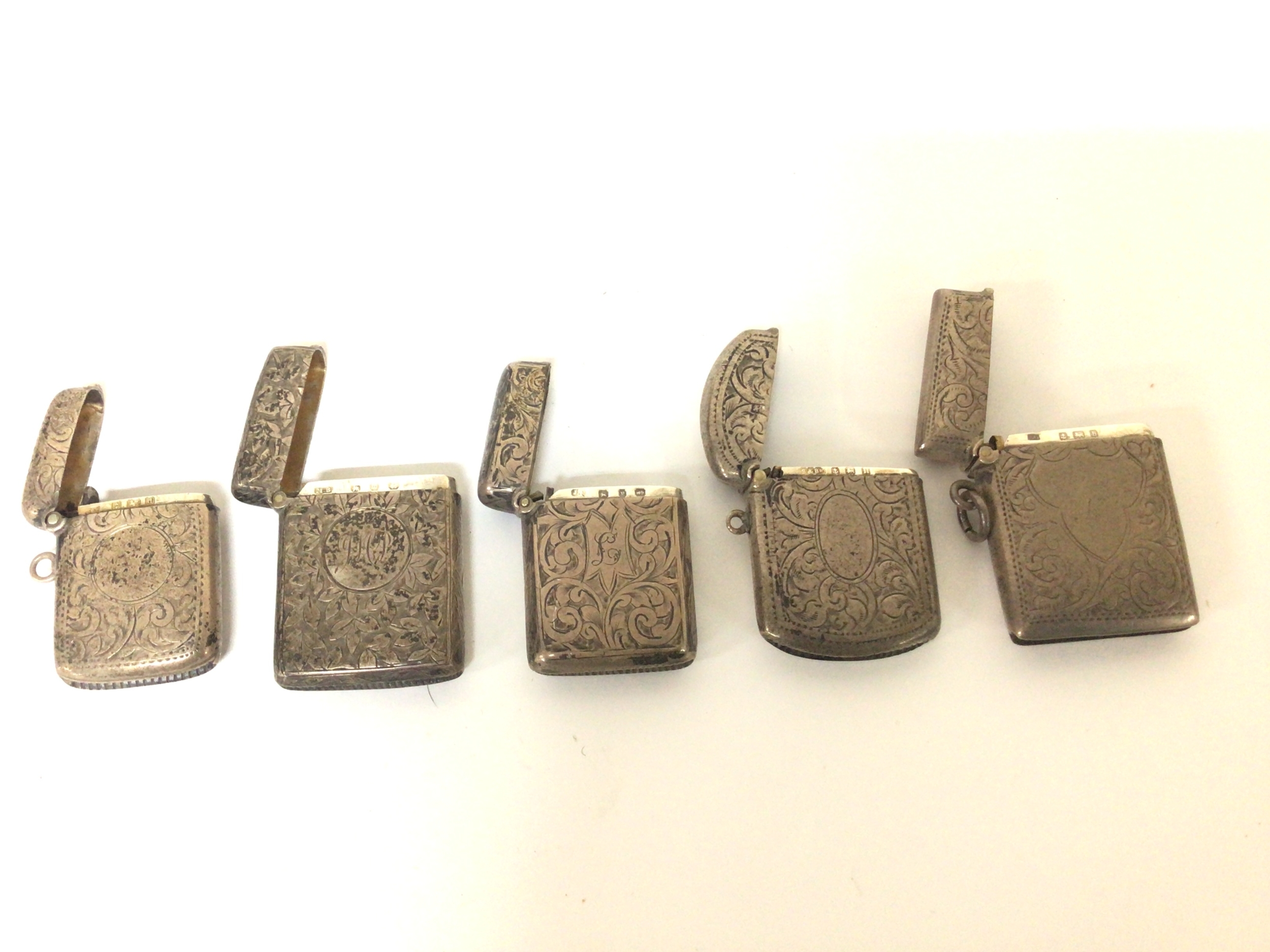  Five silver Victorian and later silver Vesta cases with scroll decoration. 95cm.