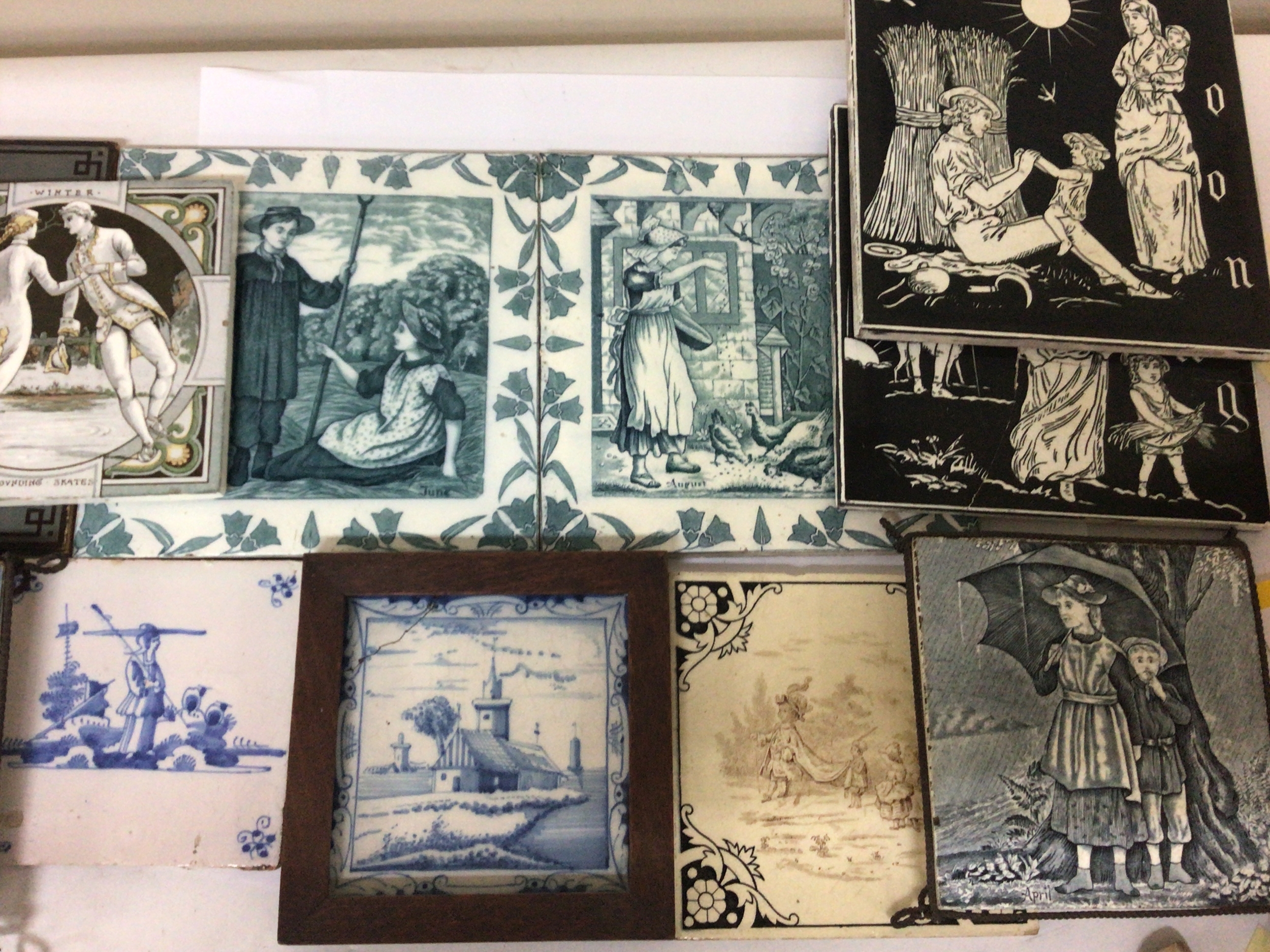  A collection of Victorian ceramic tiles including some set in metal stands delft tiles Minton china Works and others 