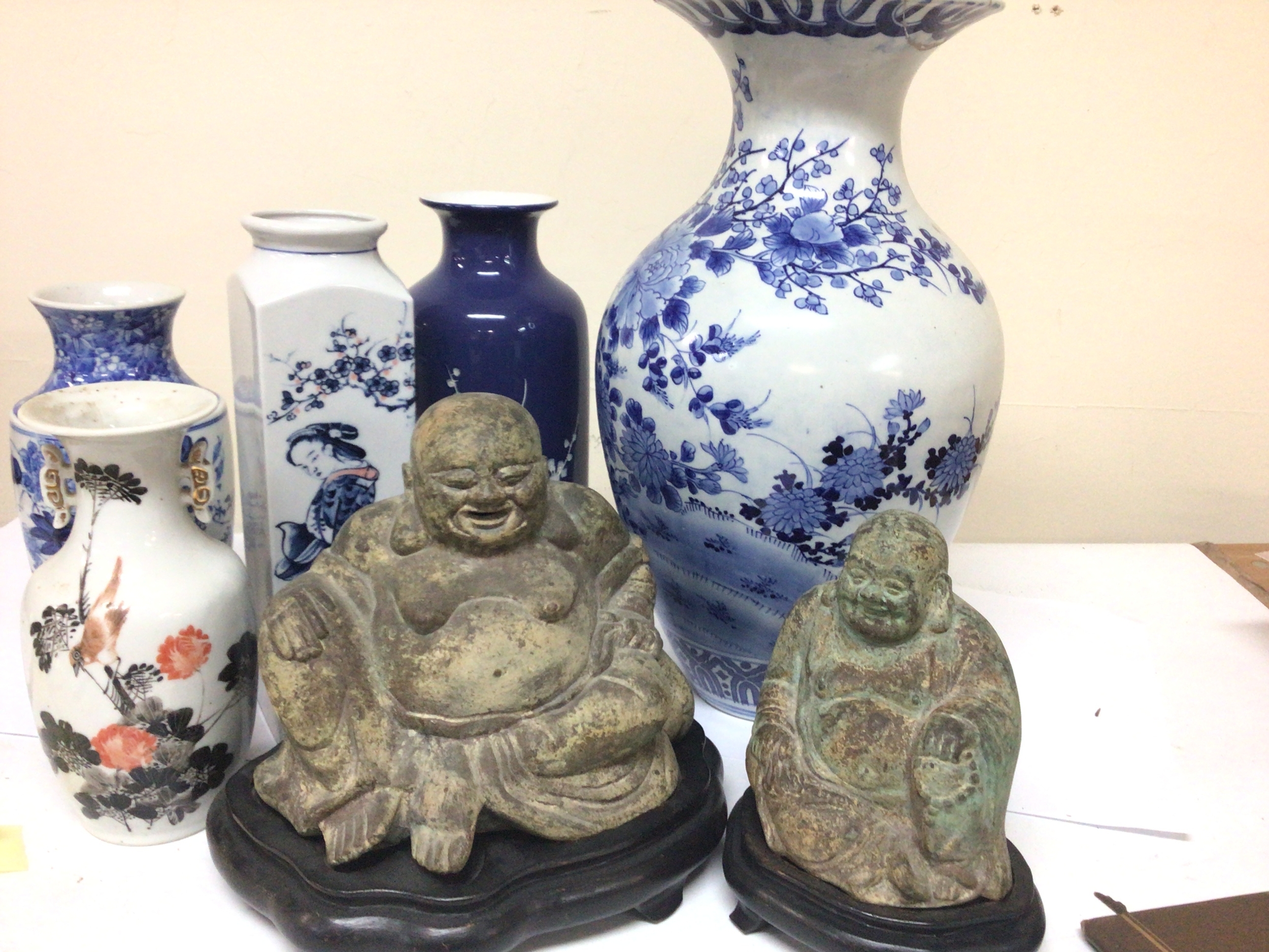Two cast metal seated figures of buddha on stands and Chinese and Japanese vases 