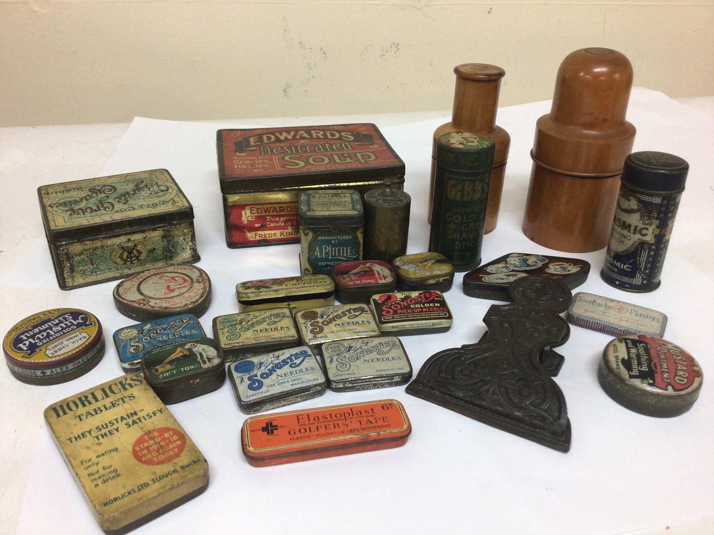  A collection of Vintage gramophone needle tins and other tins a cast iron paper clip and treen wood vessels.  