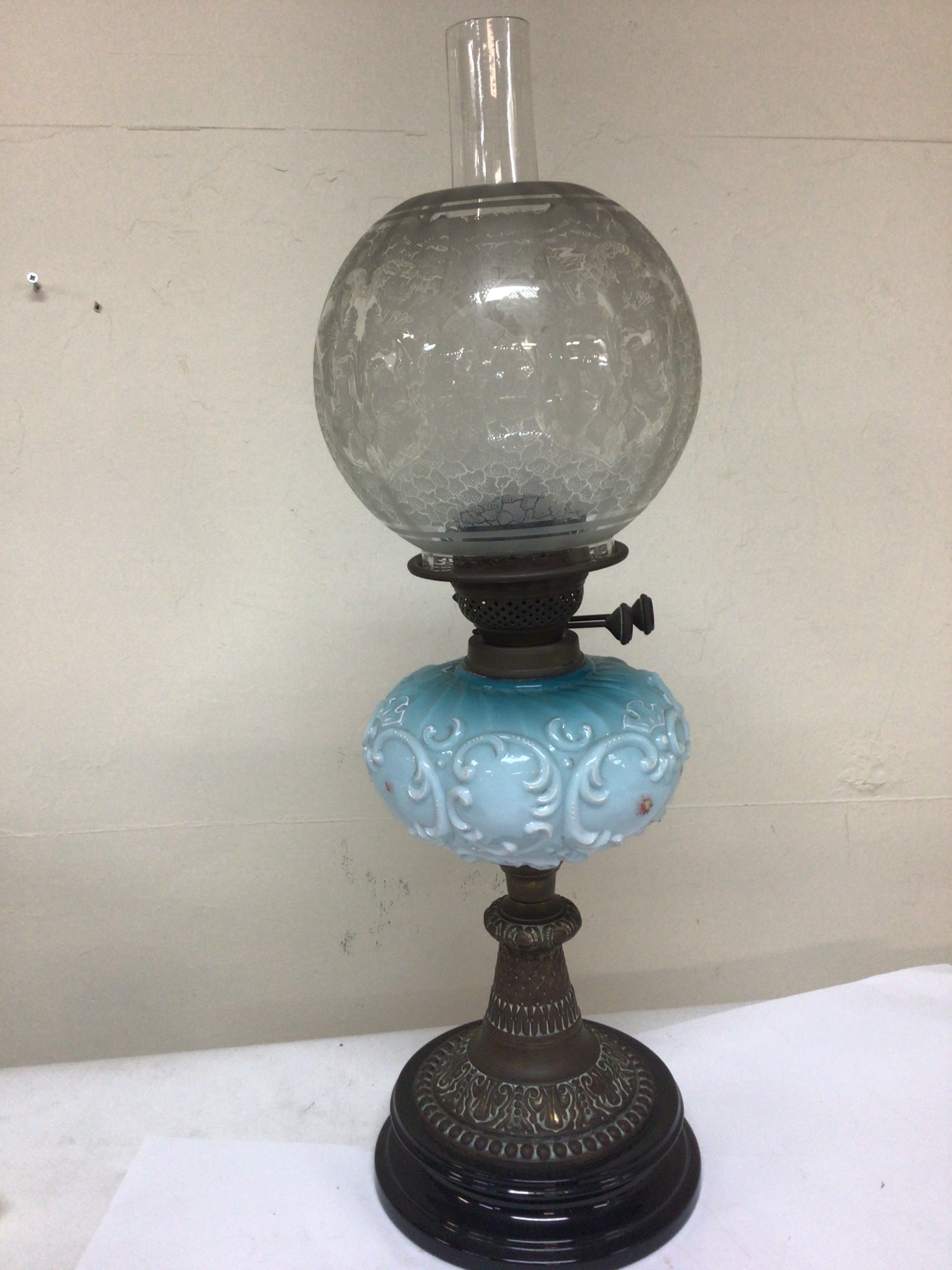  A Victorian oil lamp with a coloured glass reservoir acid etched shade  