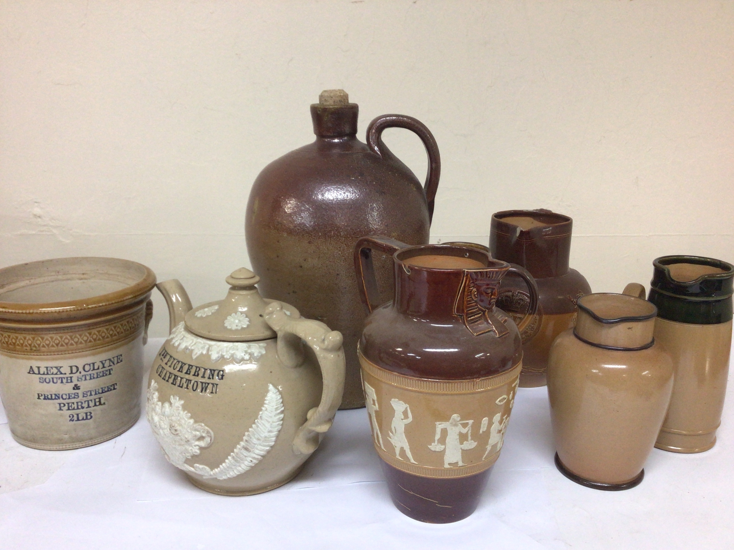  A nice example of a Victorian bespoke salt glazed tea pot with the inscription Mrs Pickering Chapeltown no obvious damage a salt glazed stoneware flagon, a Scottish stoneware storage jar Perth and other Lambeth and Royal Doulton stoneware. 